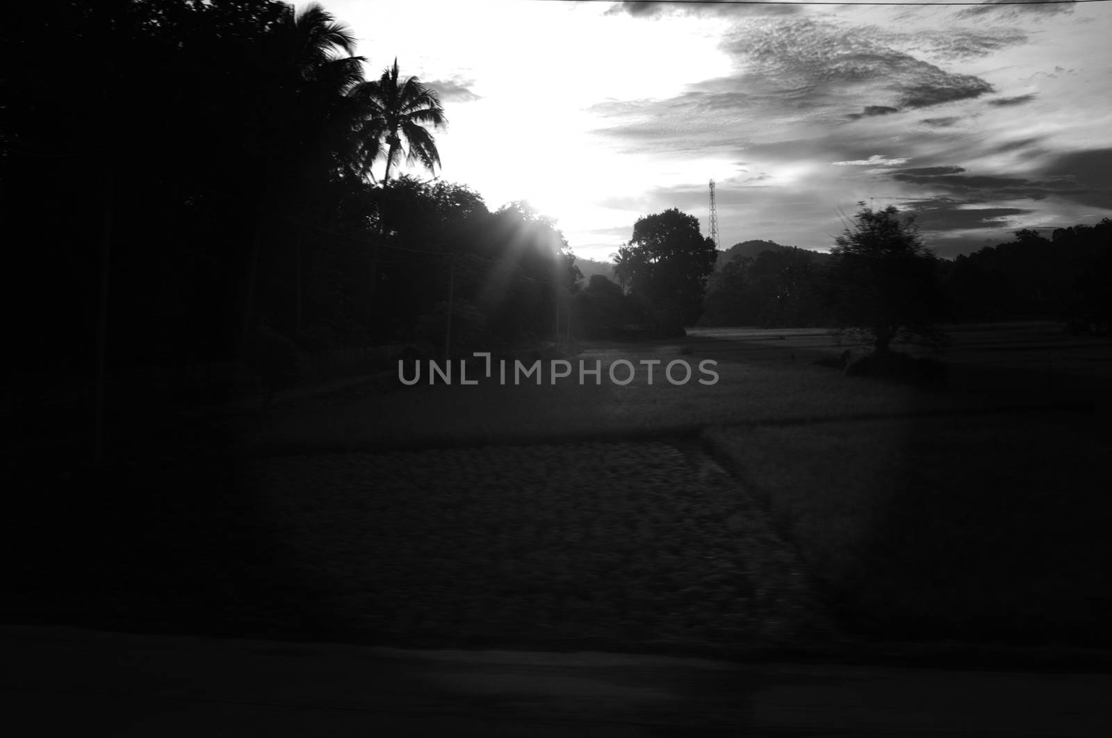 A colorful sunup above a small train station in thailand 