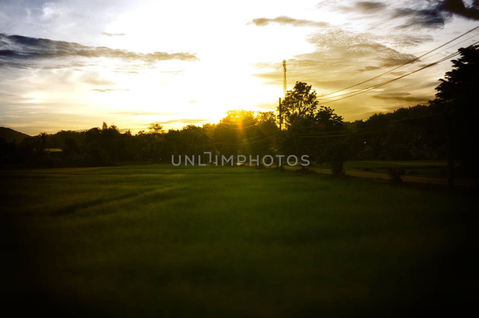 A colorful sunup above a small train station in thailand , Effect Golden light