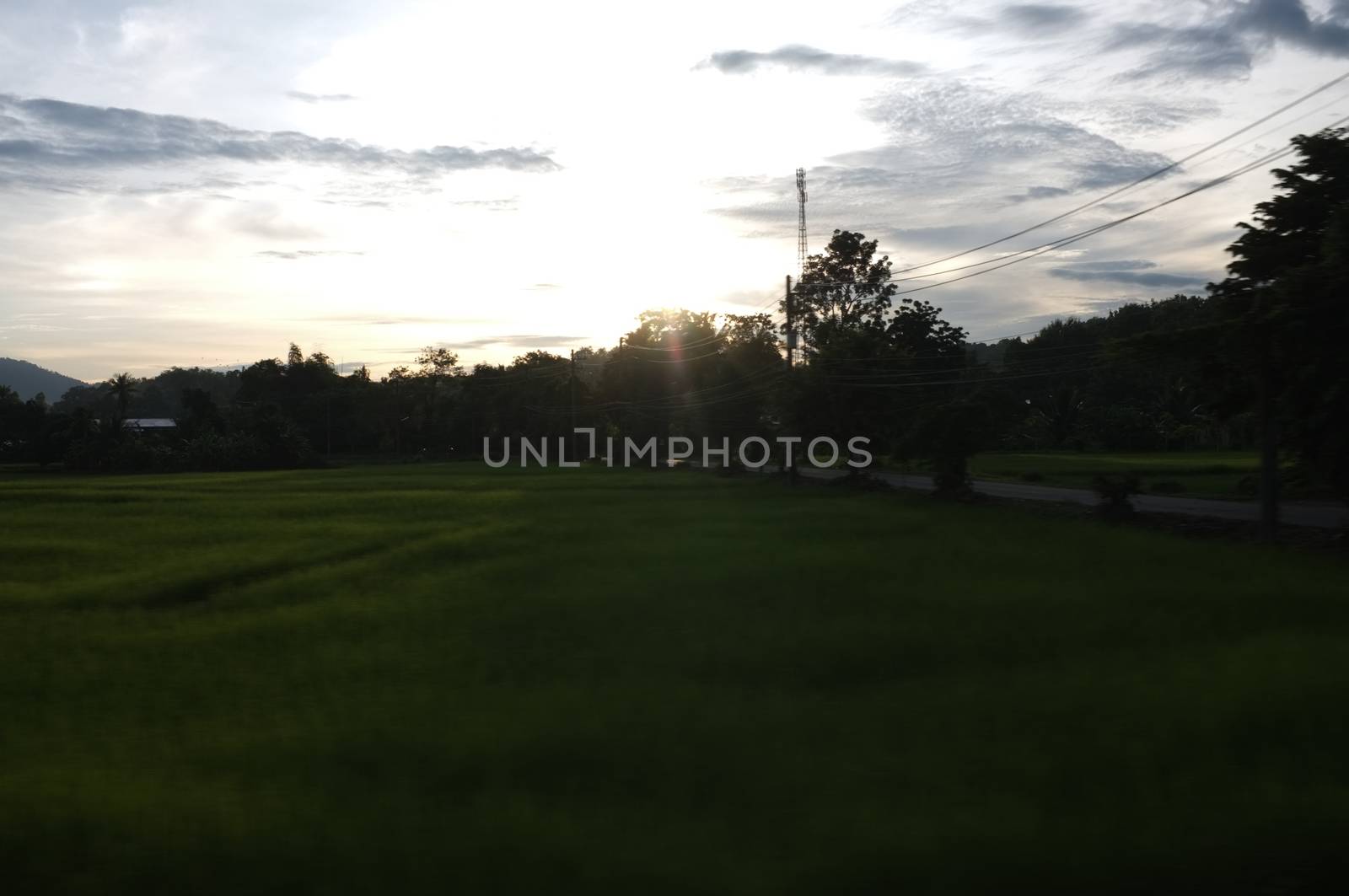 A colorful sunup above a small train station in thailand 