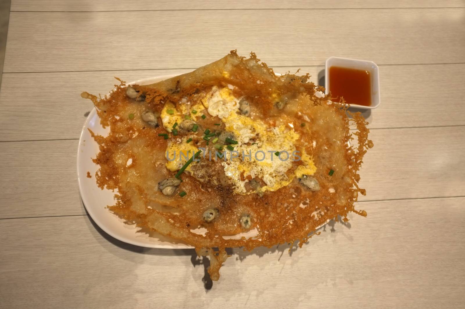 Crisp fried mussel pancakes, Fried oyster with eggs in Rice and Curry Shop at Central Village outlet near Suvarnabhumi , Thailand