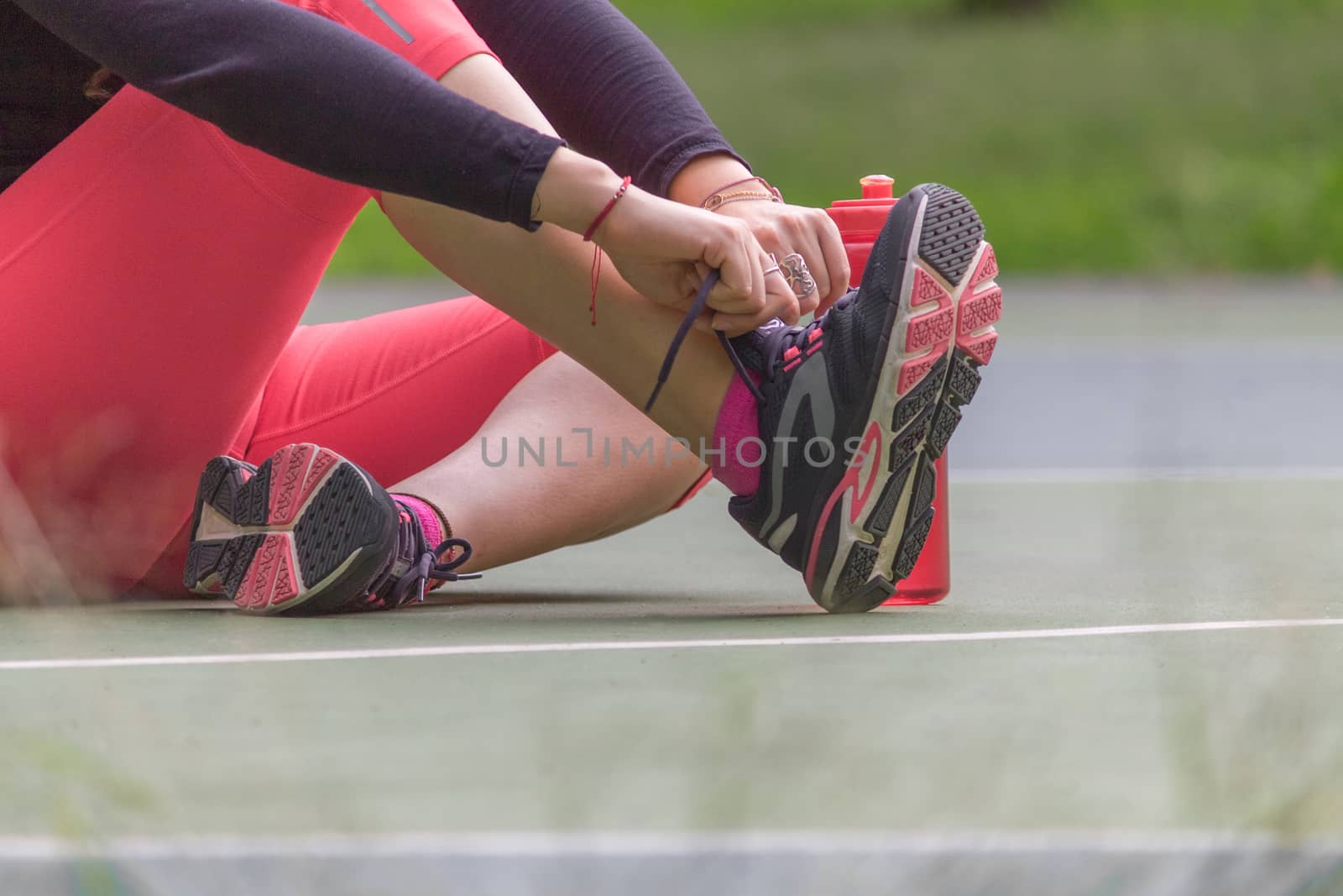 Woman adjusting her tennis shoes before running