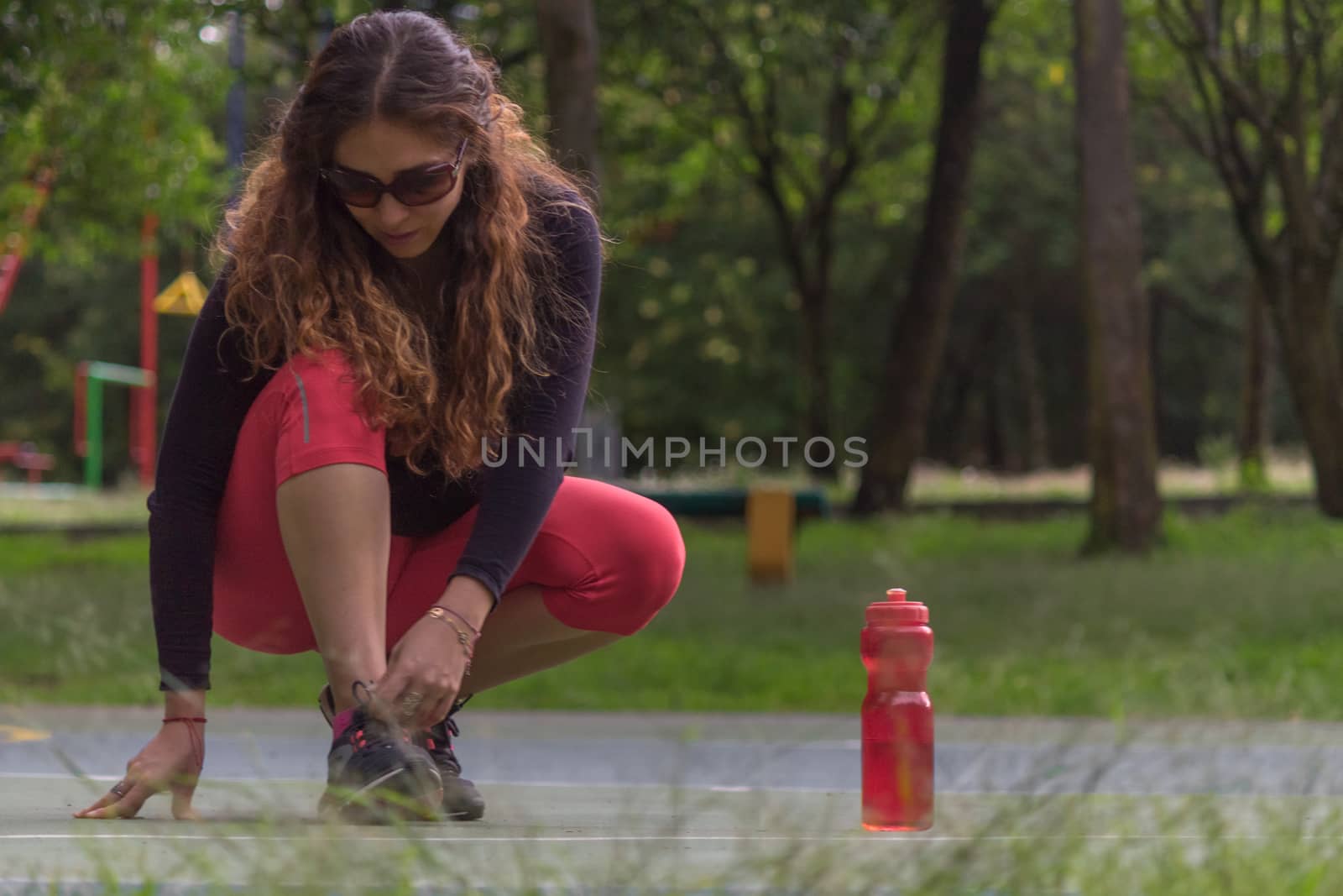 Woman adjusting her tennis shoes before running