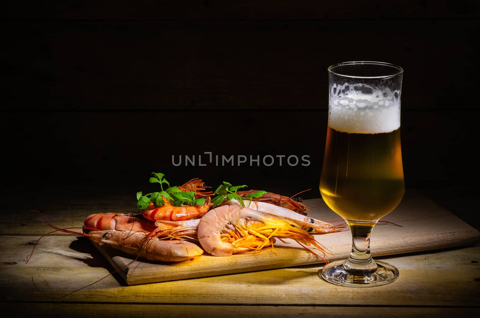 Glass of cold beer with delicious shrimp. by dmitry_derenyuk