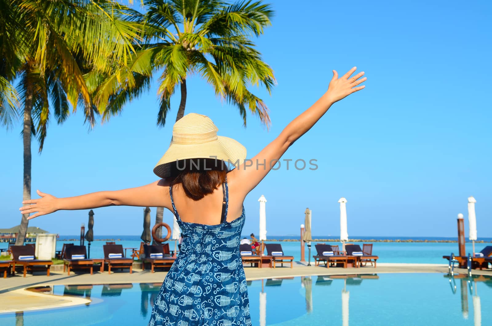 Beautiful asian young woman in sunhat relaxed at tropical beach in Maldives