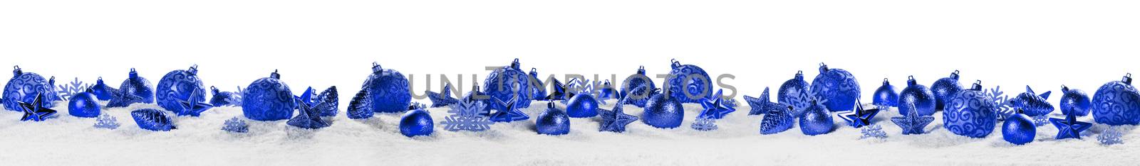 Christmas border with blue ornaments on snow isolated on white background