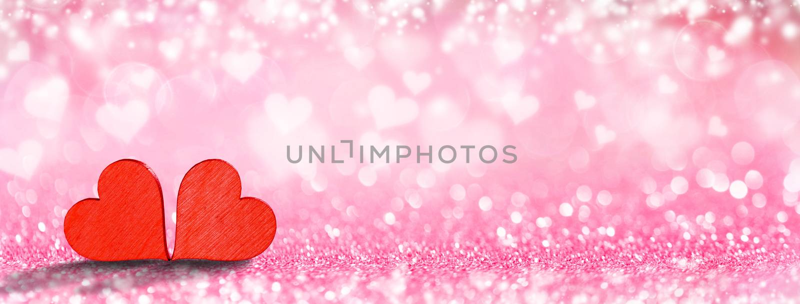 Two handmade wooden red hearts on beautiful bokeh background. Vintage style. Love Valentine's Day concept.