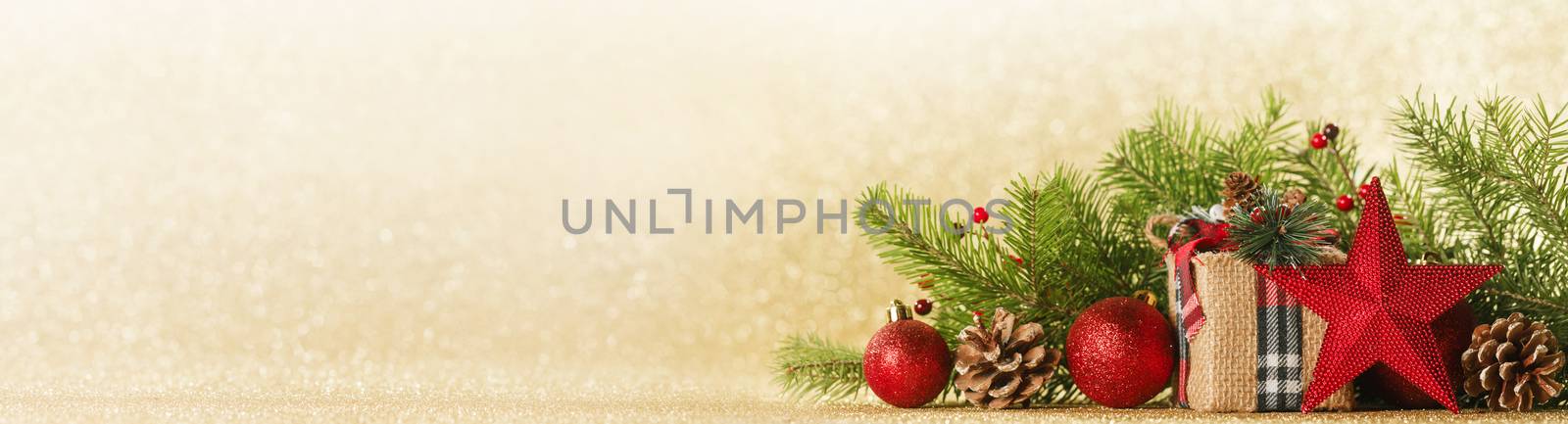 Christmas toys, decorations, present gift box wrapped in kraft paper on golden glitter background, copy space