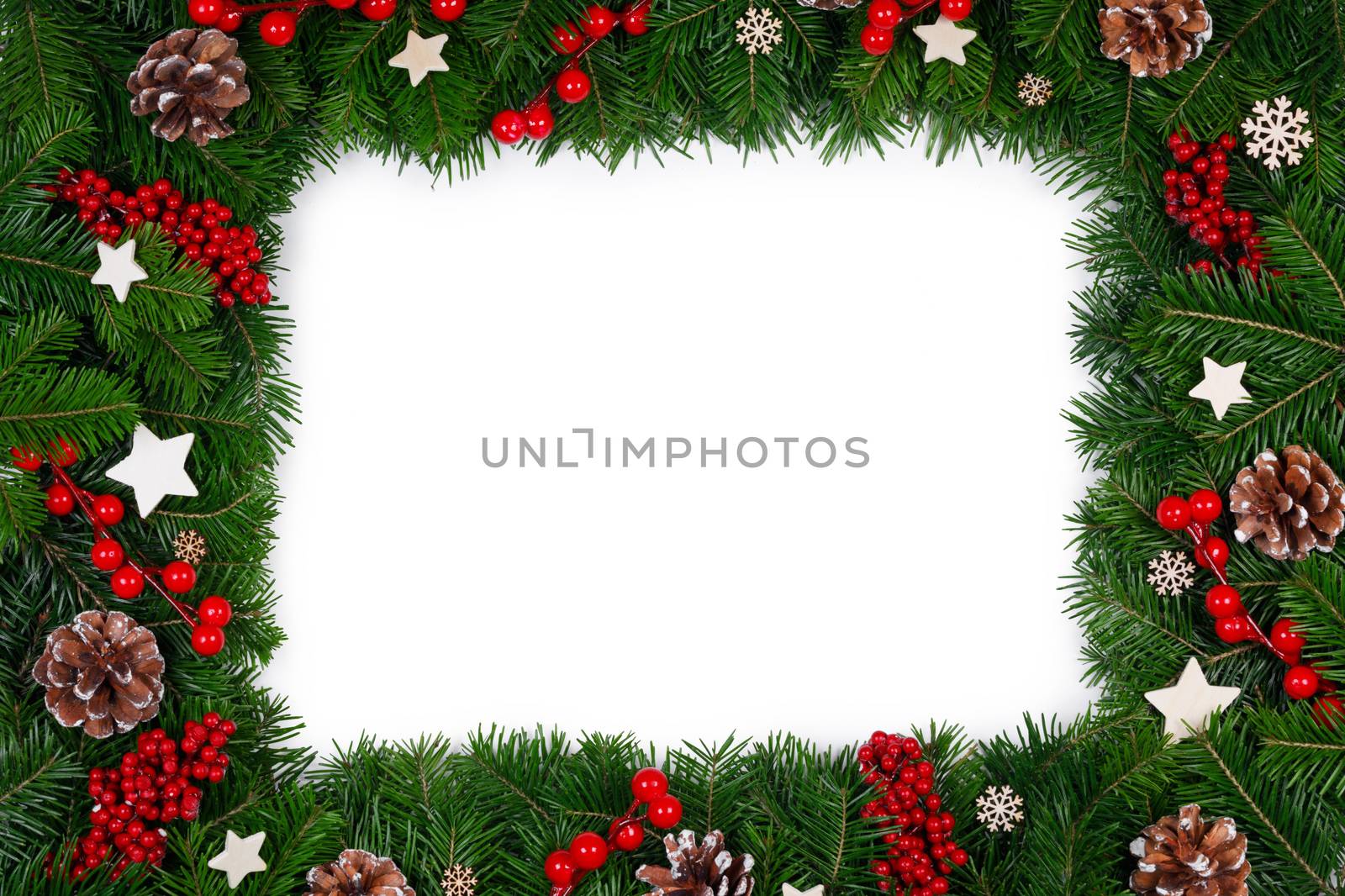 Christmas Border frame of tree branches on white background with copy space isolated, red and white decor, berries, stars, cones