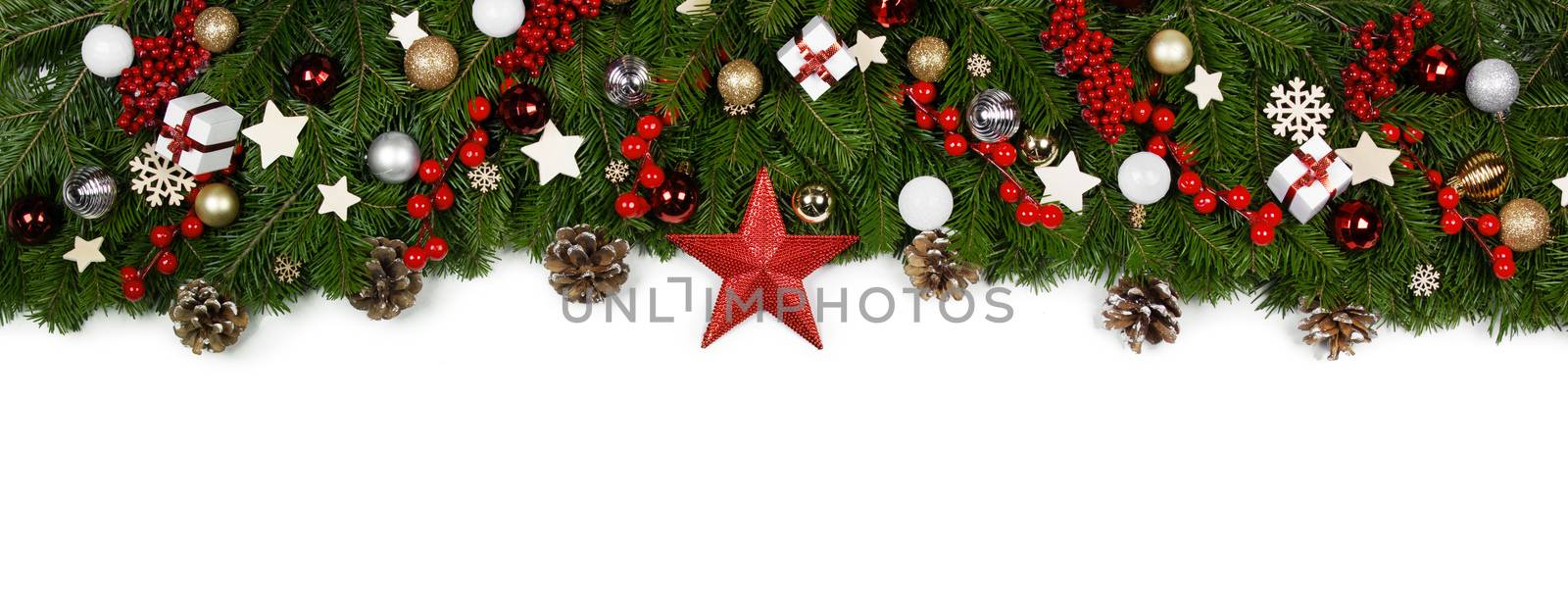 Christmas Border frame of tree branches on white background with copy space isolated, red and white decor, berries, stars, cones