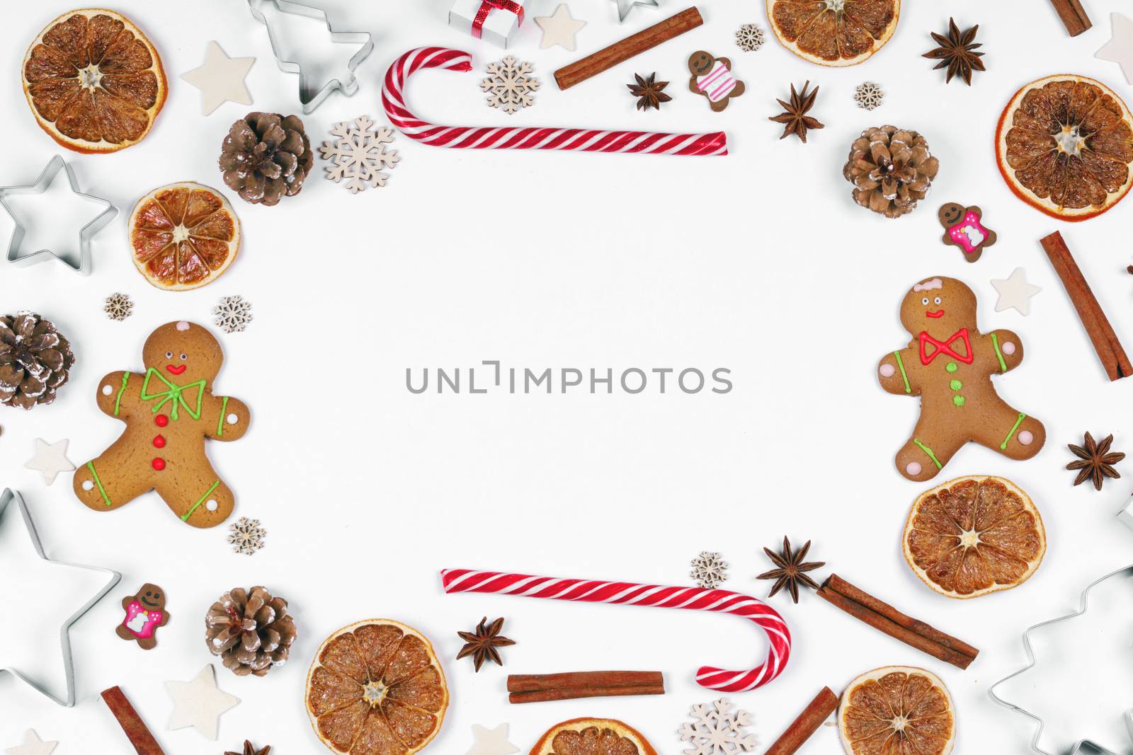 Christmas food frame. Gingerbread cookies, spices and decorations on white background with copy space