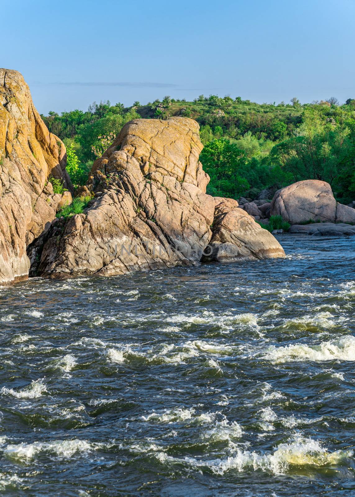 The rocky banks of the Southern Bug River near the village of Migiya in Ukraine on a sunny summer day