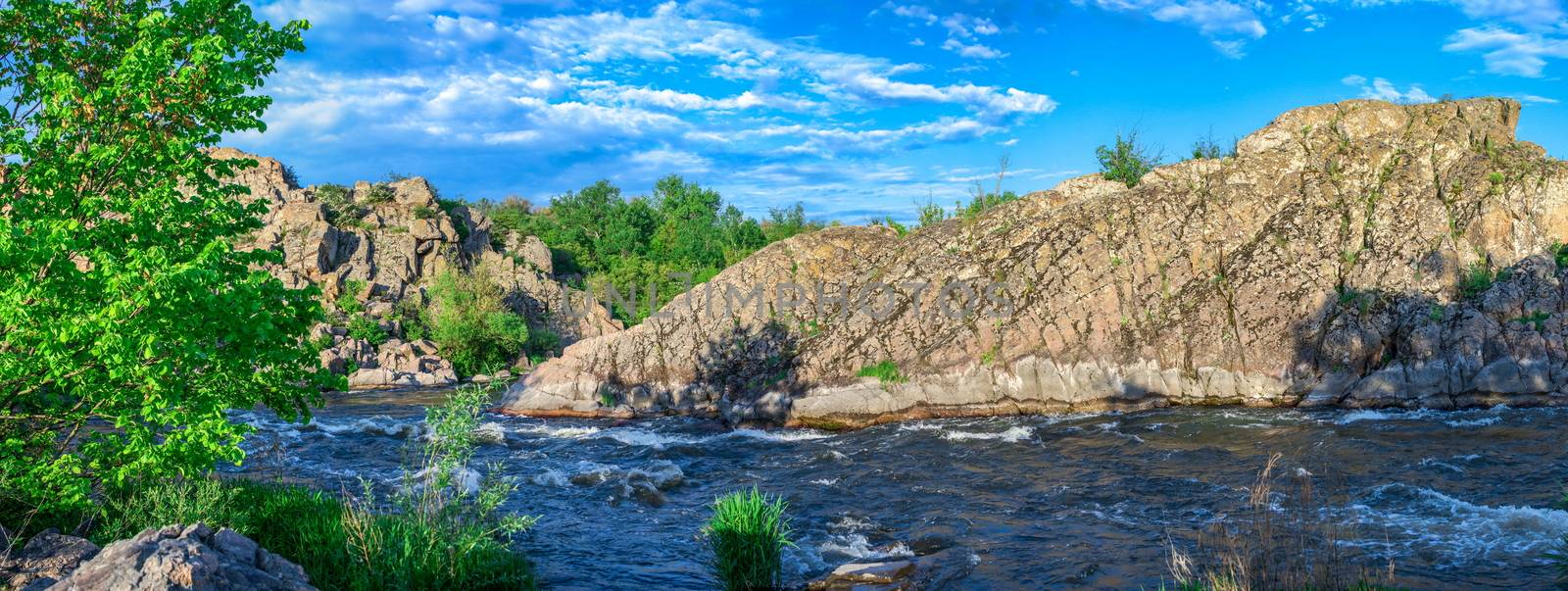 The rocky banks of the Southern Bug River near the village of Migiya in Ukraine on a sunny summer day