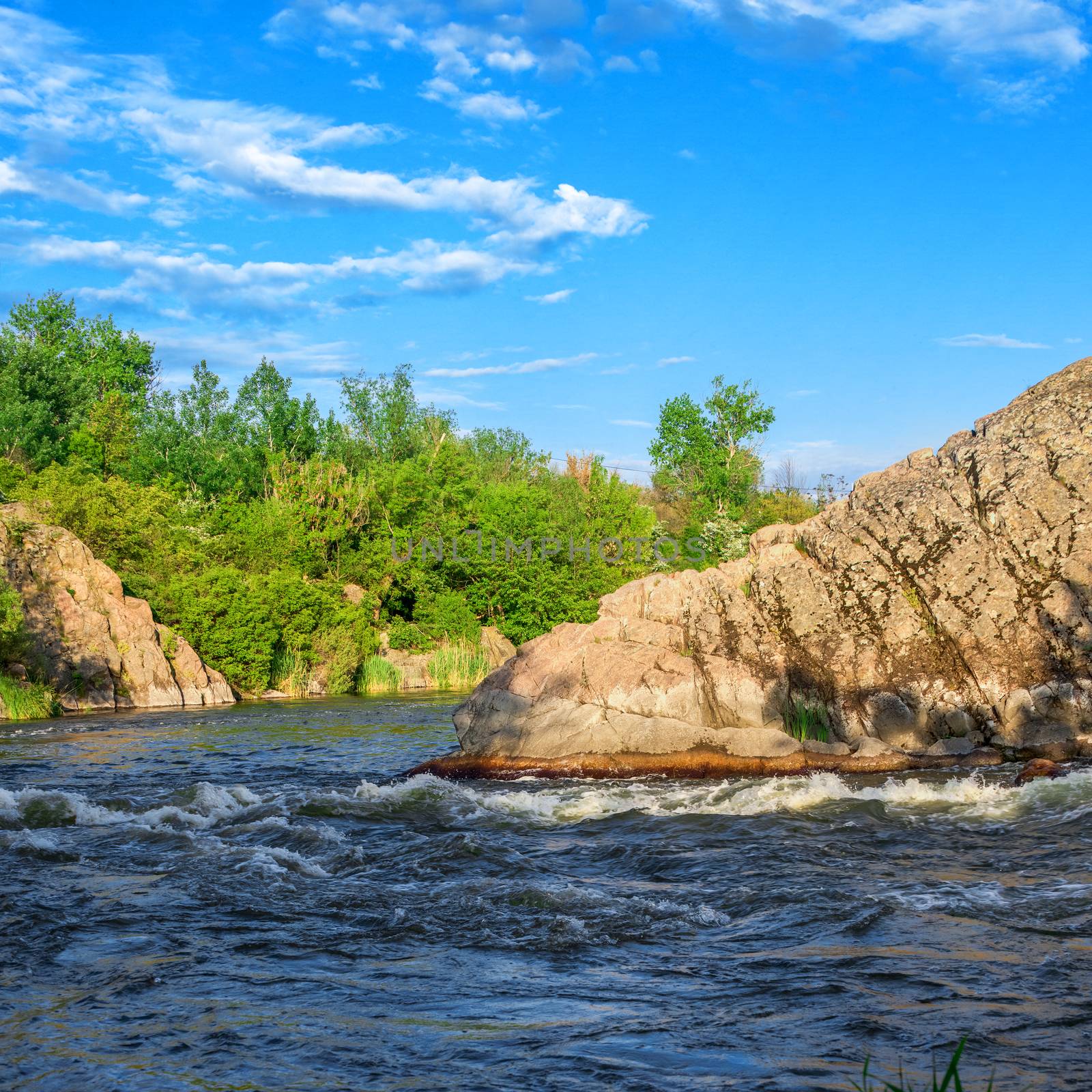 The rocky banks of the Southern Bug River near the village of Migiya in Ukraine on a sunny summer day
