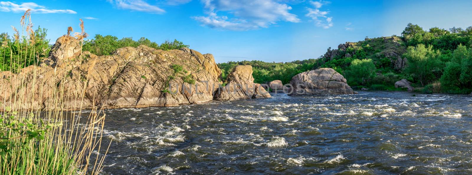 The rocky banks of the Southern Bug River near the village of Migiya in Ukraine on a sunny summer day