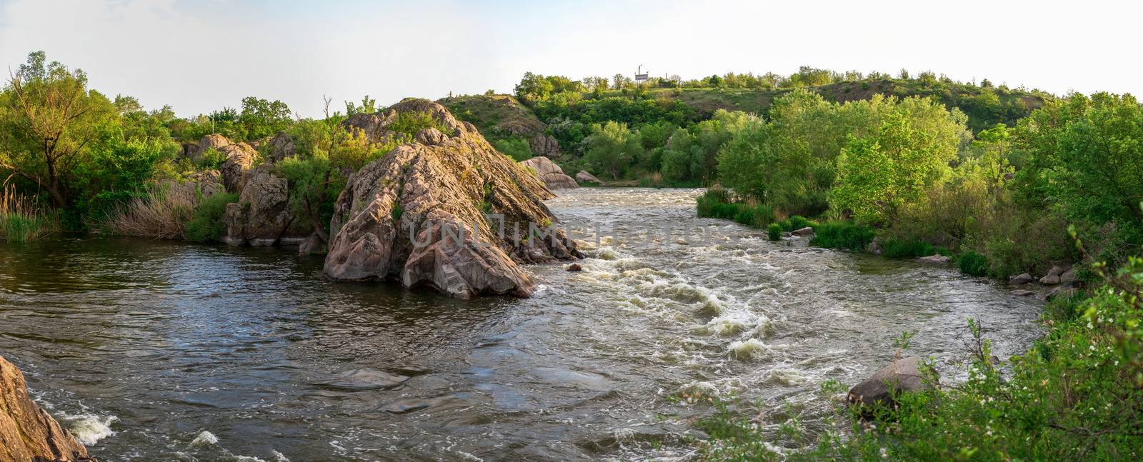 The rocky banks of the Southern Bug River near the village of Migiya in Ukraine on a sunny summer day