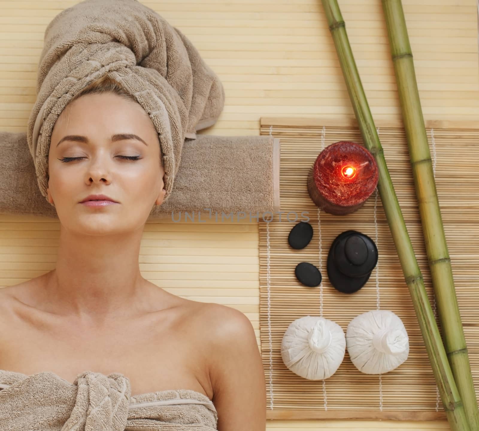 Beautiful young woman relaxing in spa salon