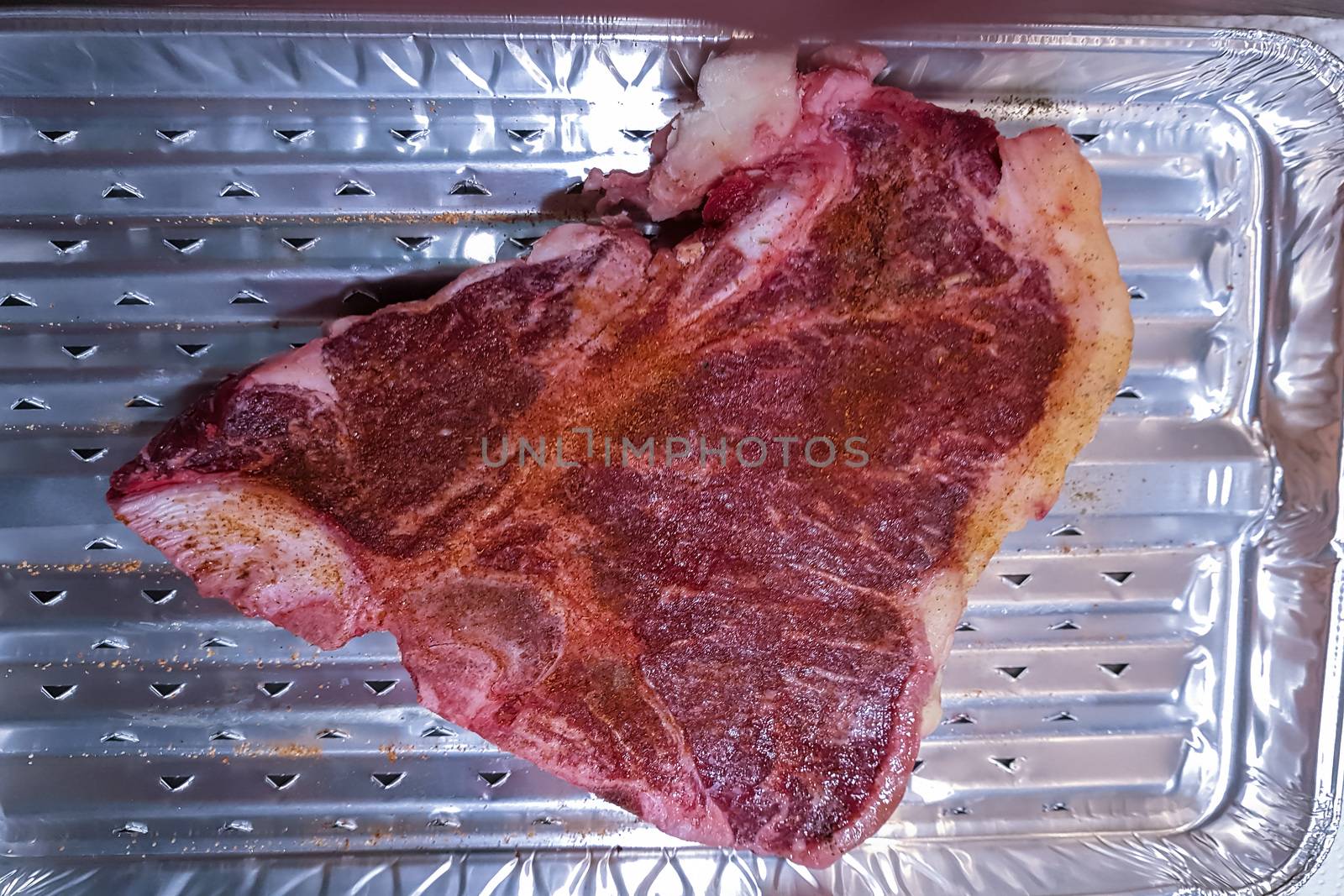 Close-up view of a Marbled Bone steak on an alu grill cup