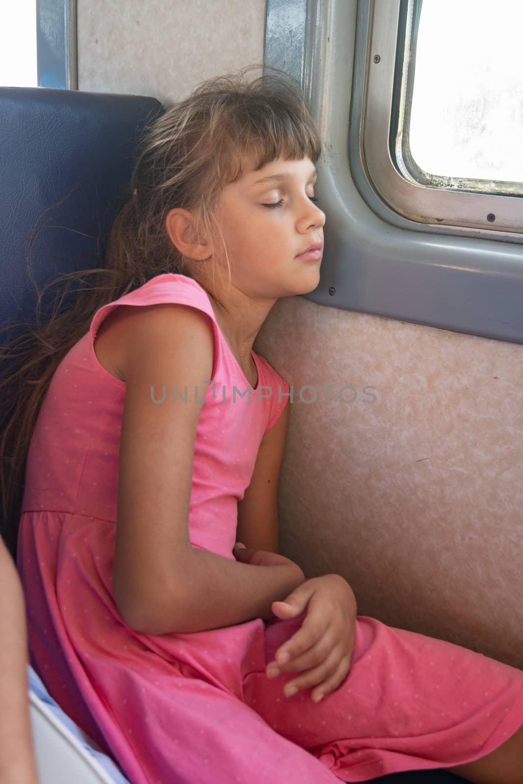 Tired girl fell asleep in an electric train