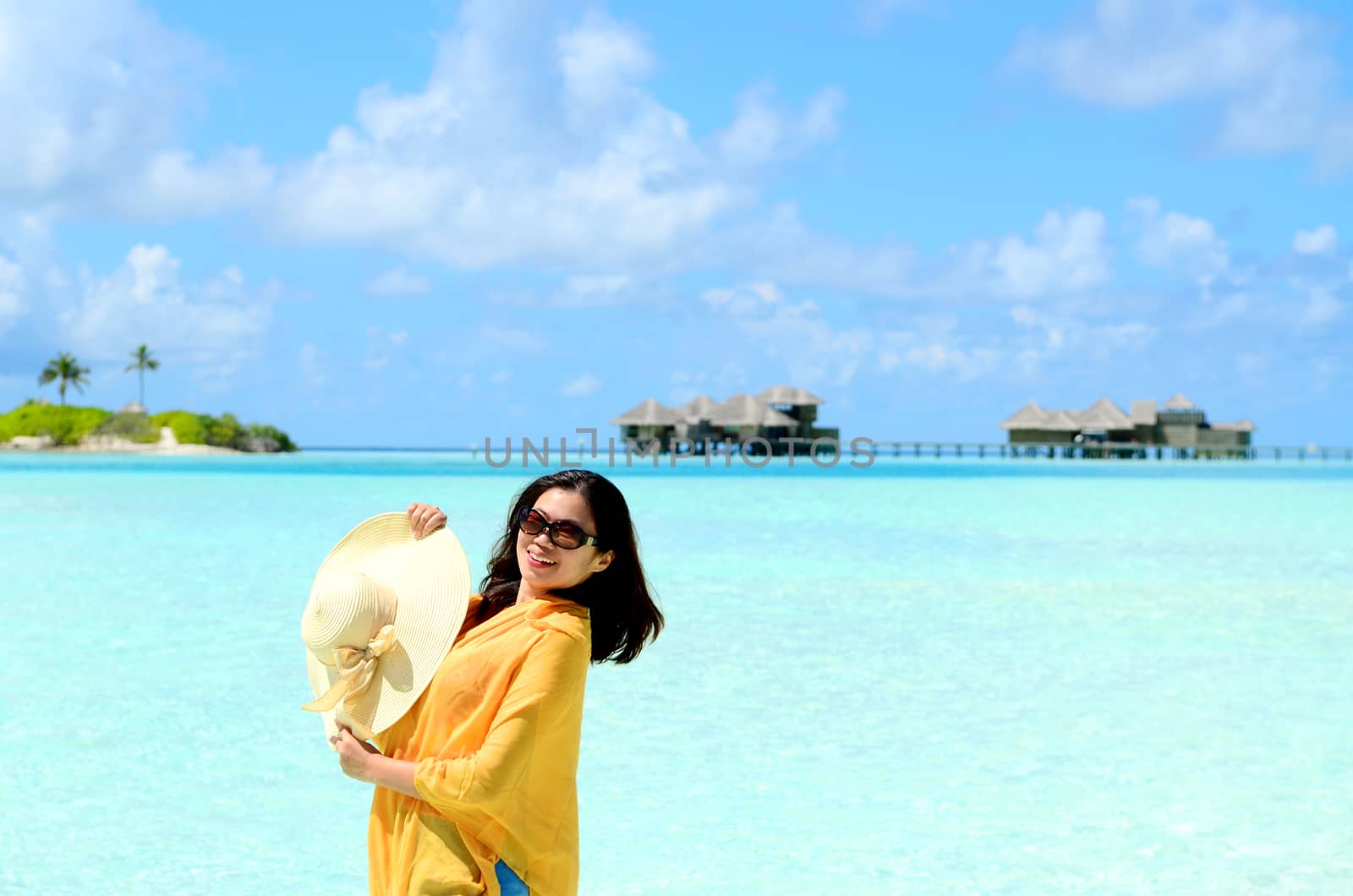 Portrait of happy young woman at  Maldives island. Travel and Vacation. 