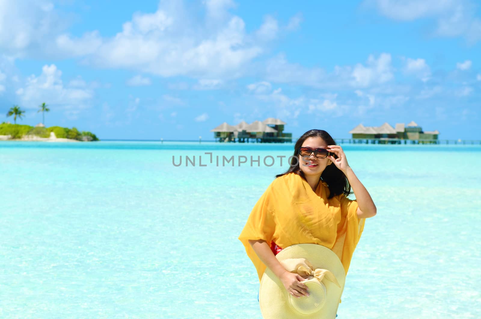 Portrait of happy young woman at  Maldives island. Travel and Vacation. 