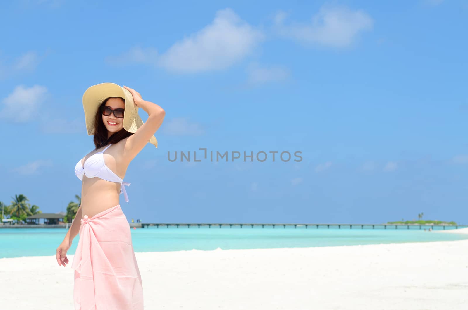 Portrait of happy young woman in sunhat at  Maldives island. Travel and Vacation. 