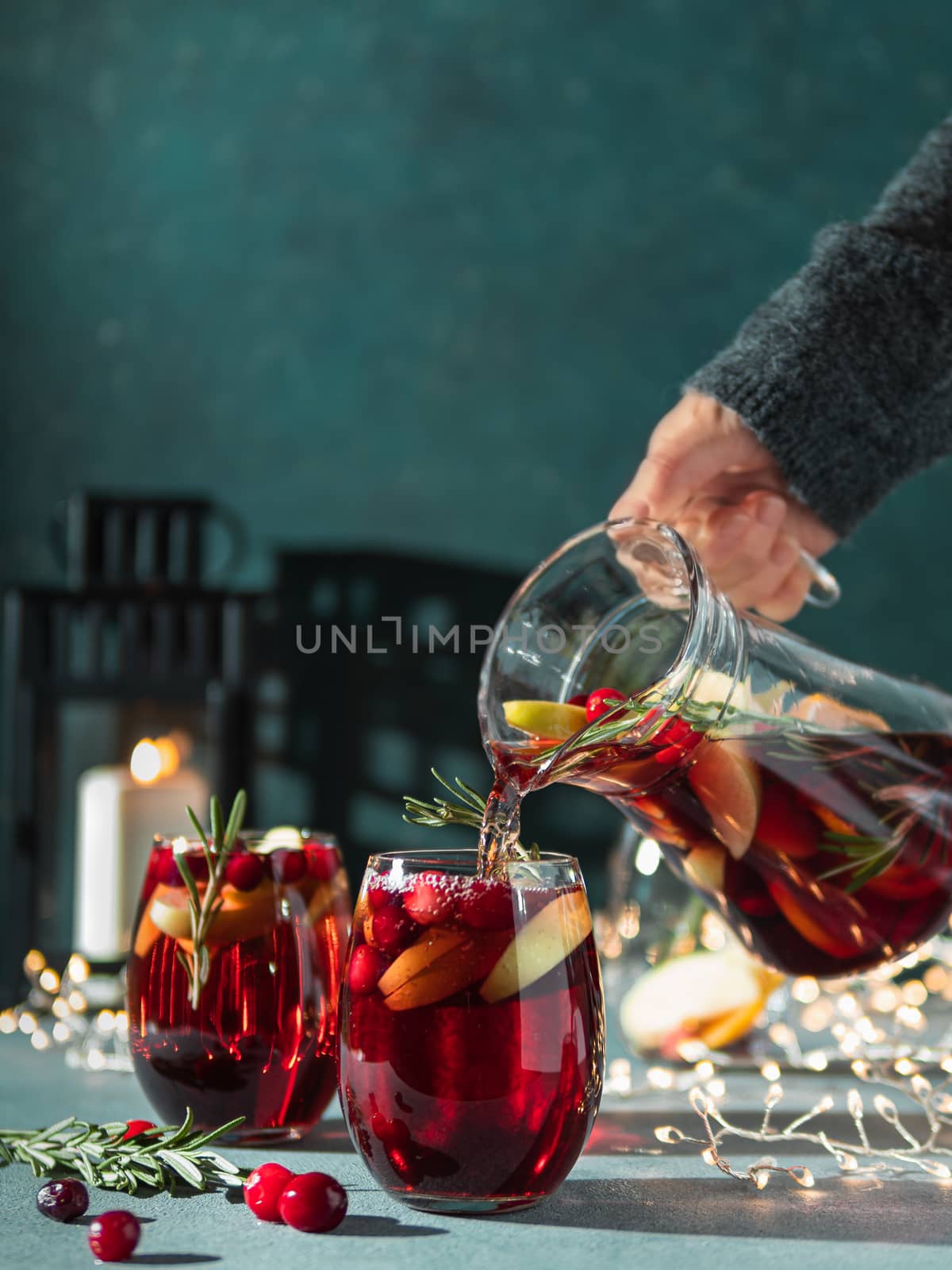 Winter sangria pouring in glasses, christmas table by fascinadora