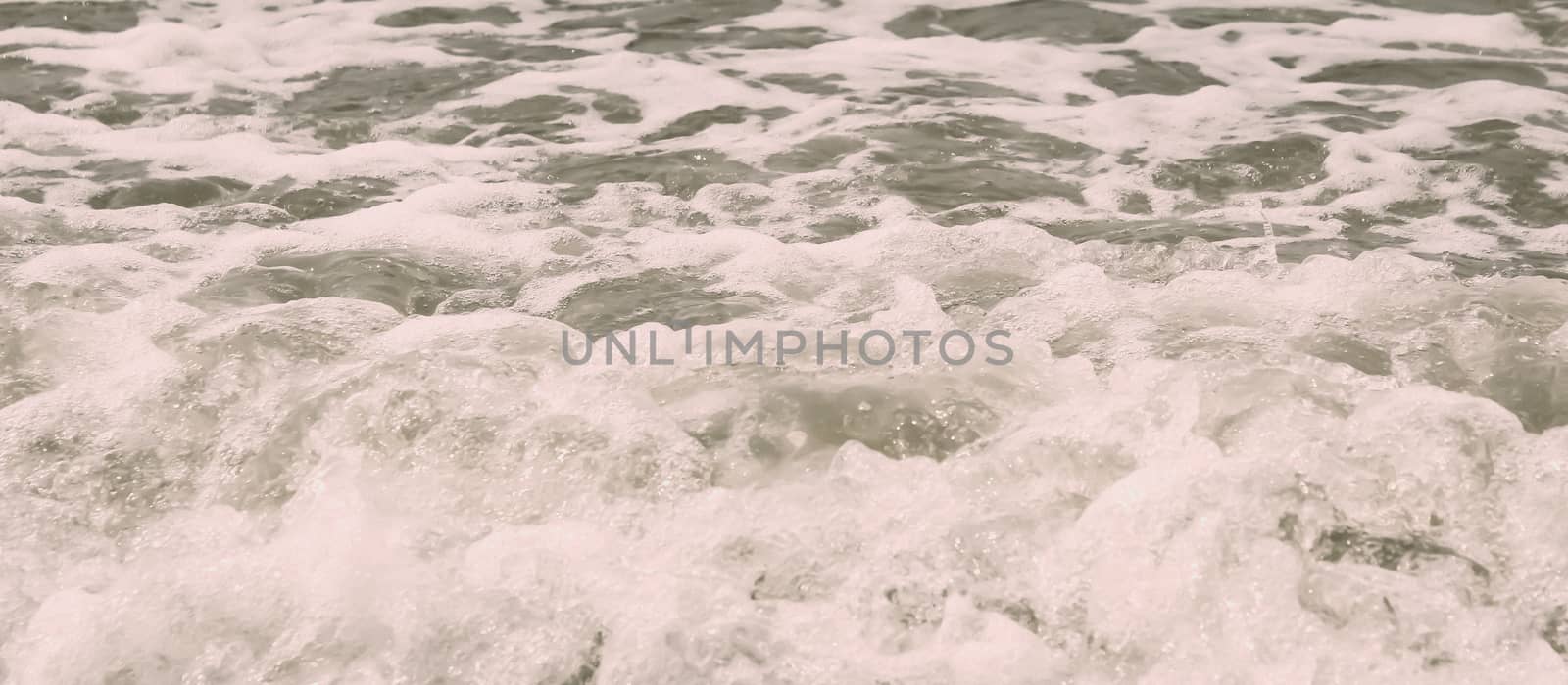High Angle View Of Rippling Splashing Ocean Waves. Rippled sea water wave Wallpaper wet background decor for mobile and desktop screens. Vintage retro style colour effect. Copy space room for text.