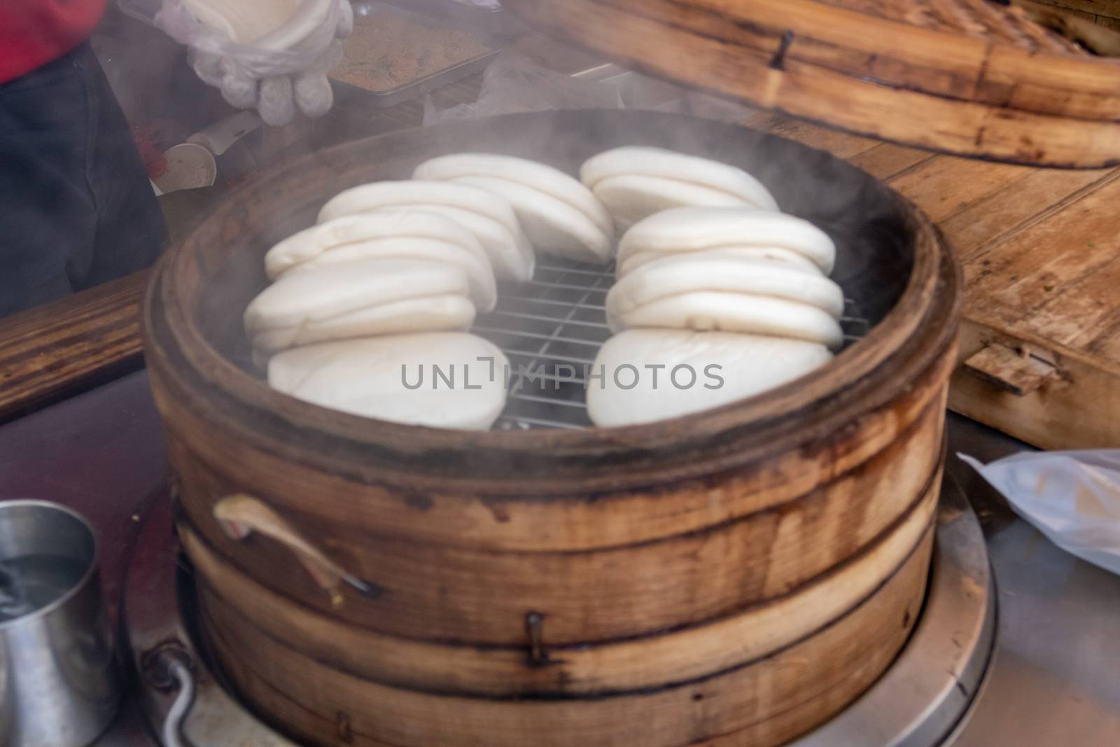 Steamed Taiwanese Guo Bao Buns in a Bamboo Steamer