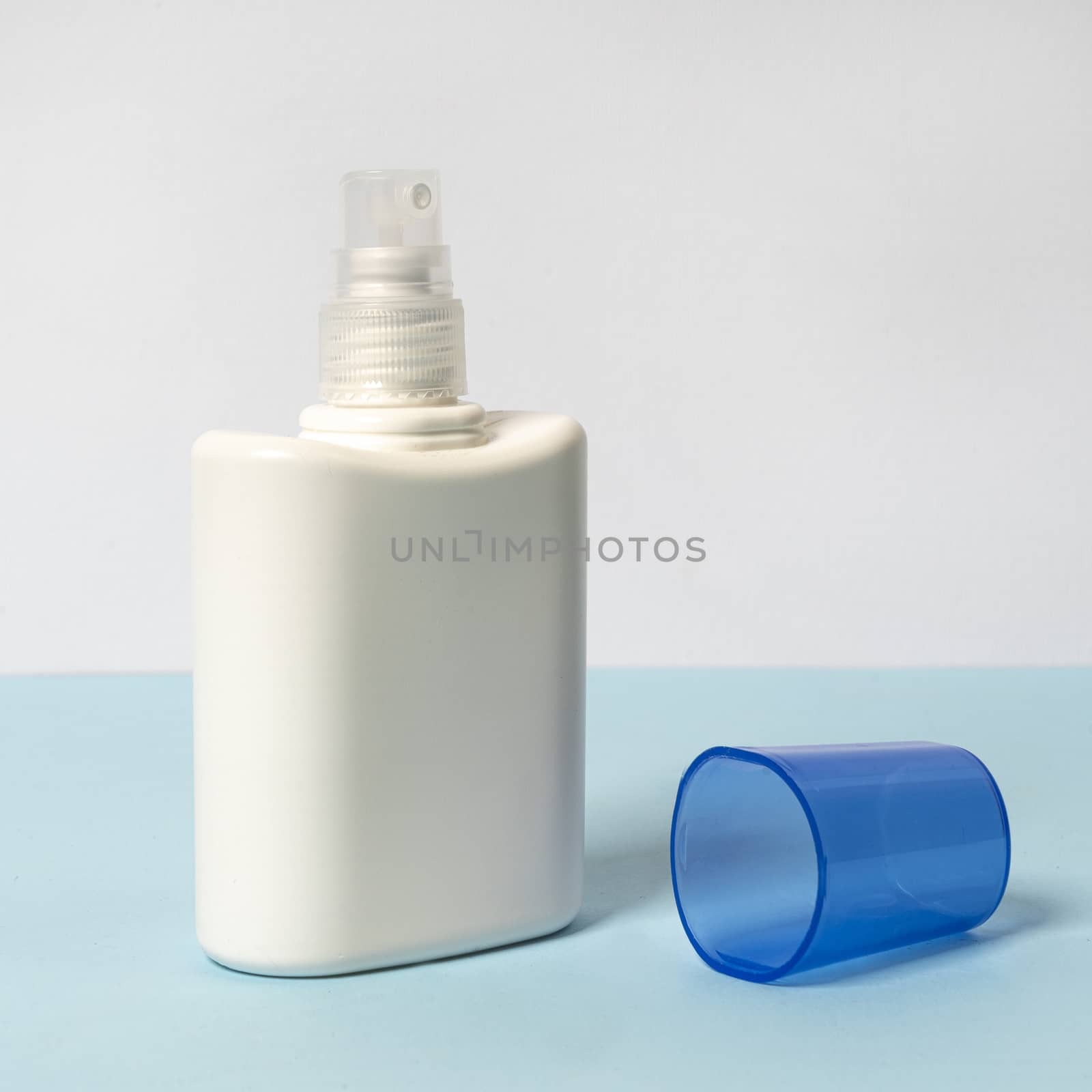 a white bottle on a colored surface