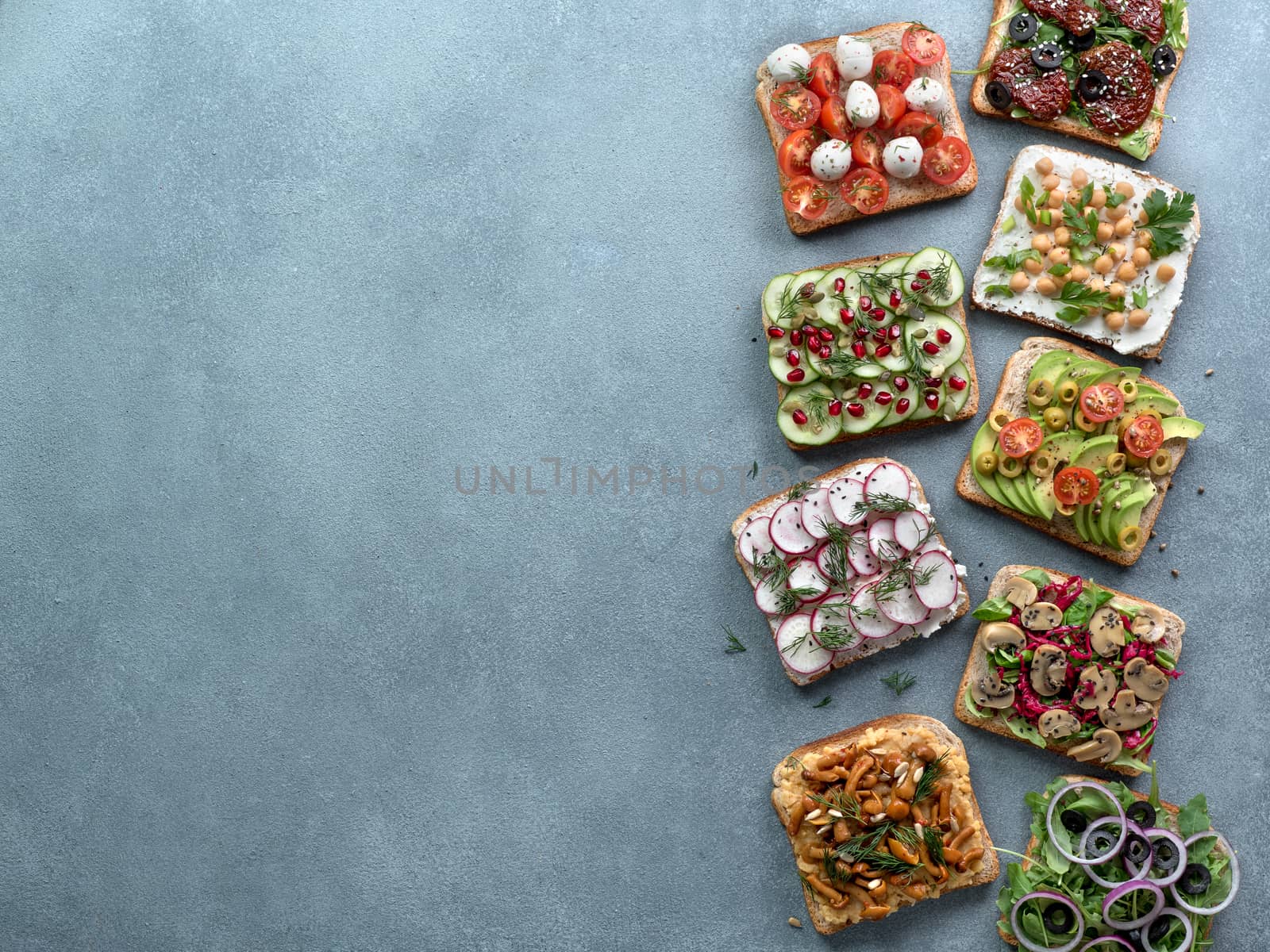 Assortment vegan sandwiches on gray stone background by fascinadora