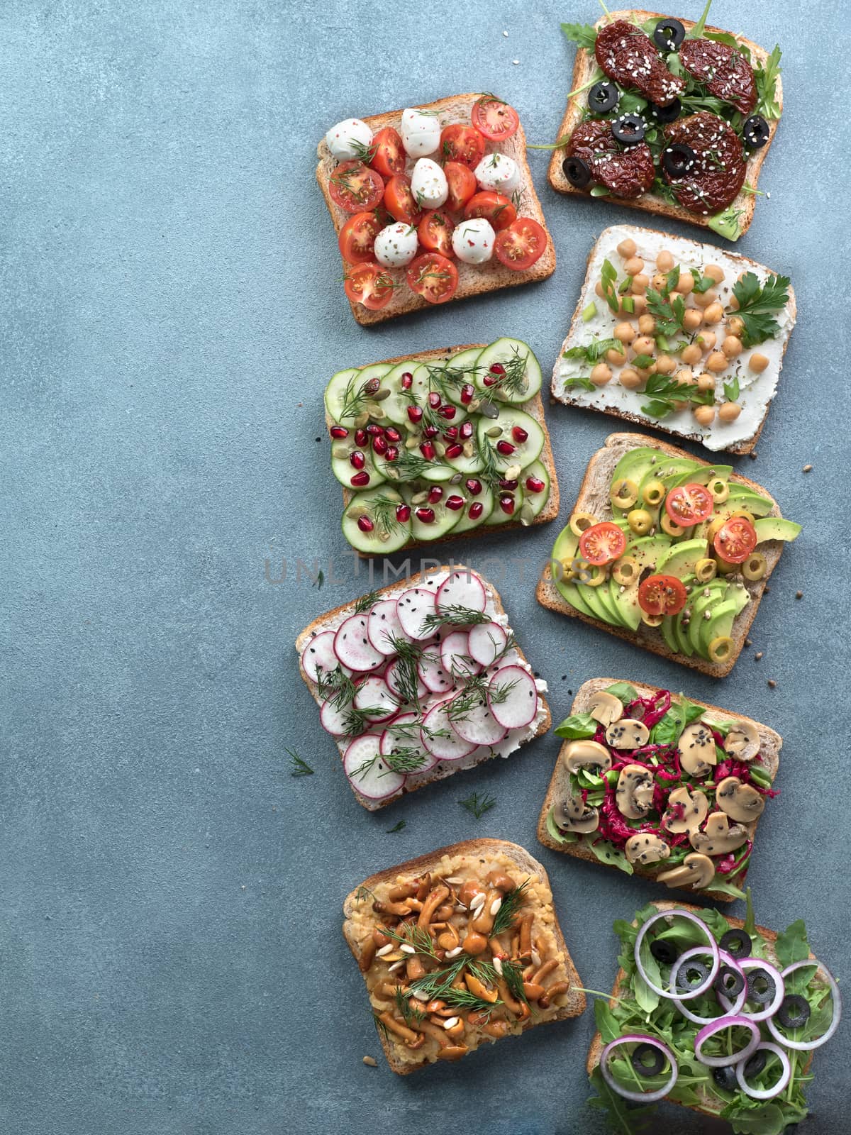 Assortment vegan sandwiches on gray stone background by fascinadora