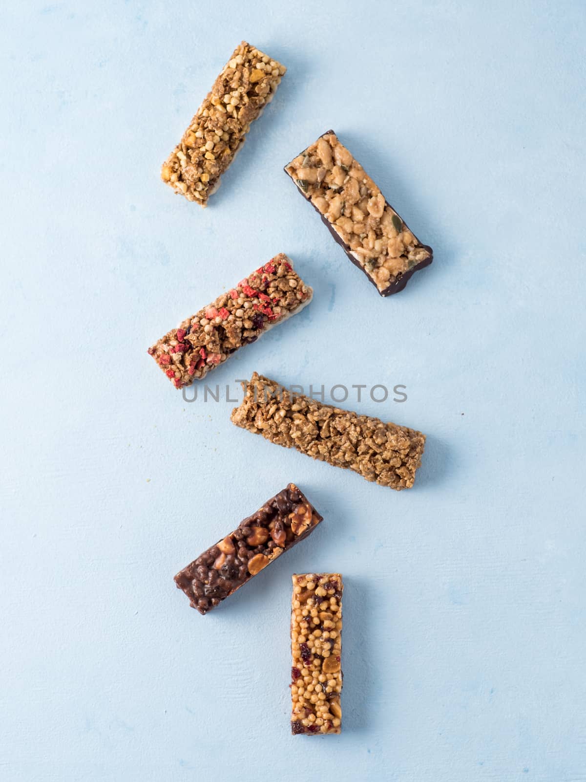 Set of different granola bars on blue background by fascinadora