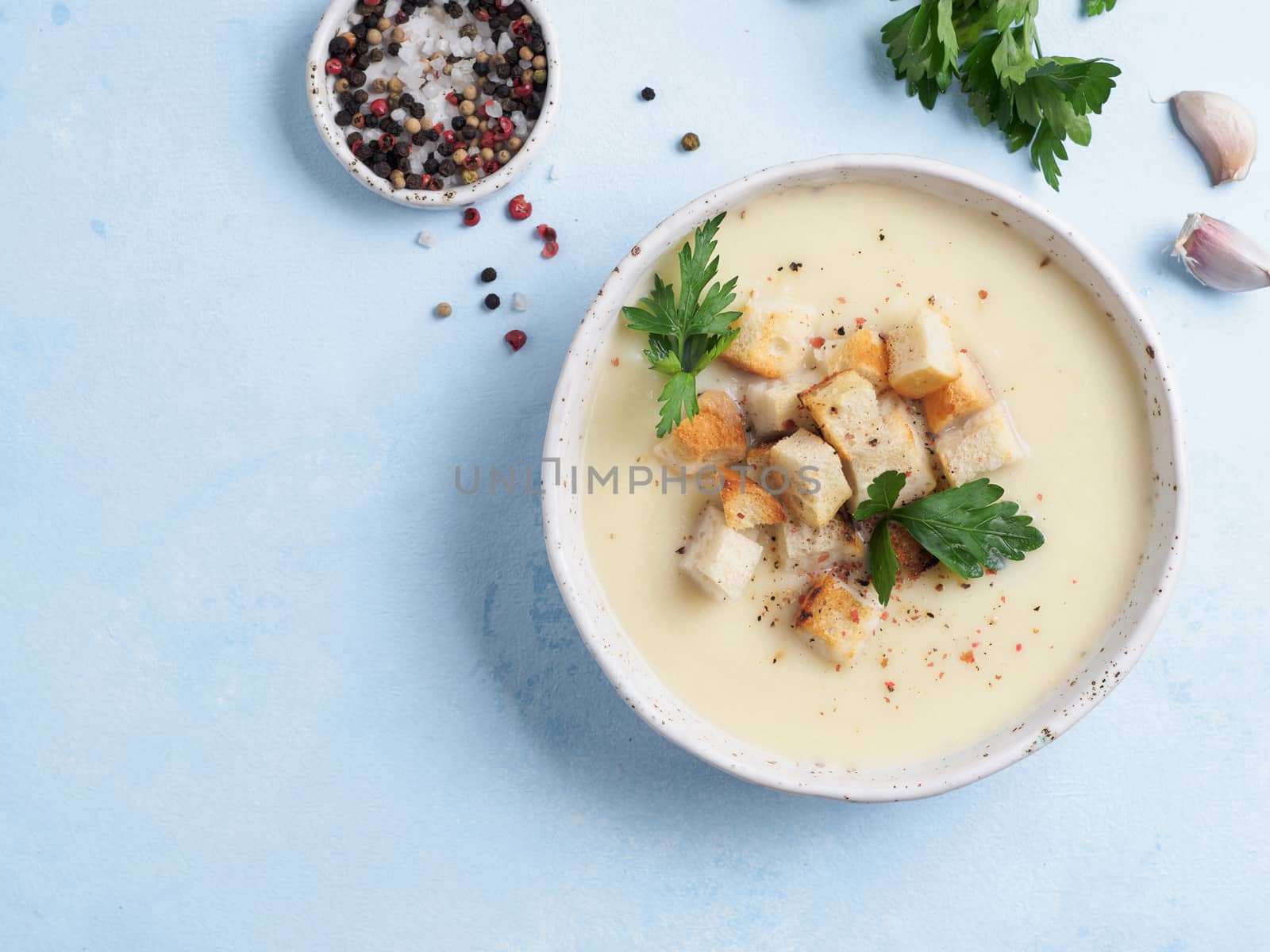cauliflower soup puree top view, copy space by fascinadora