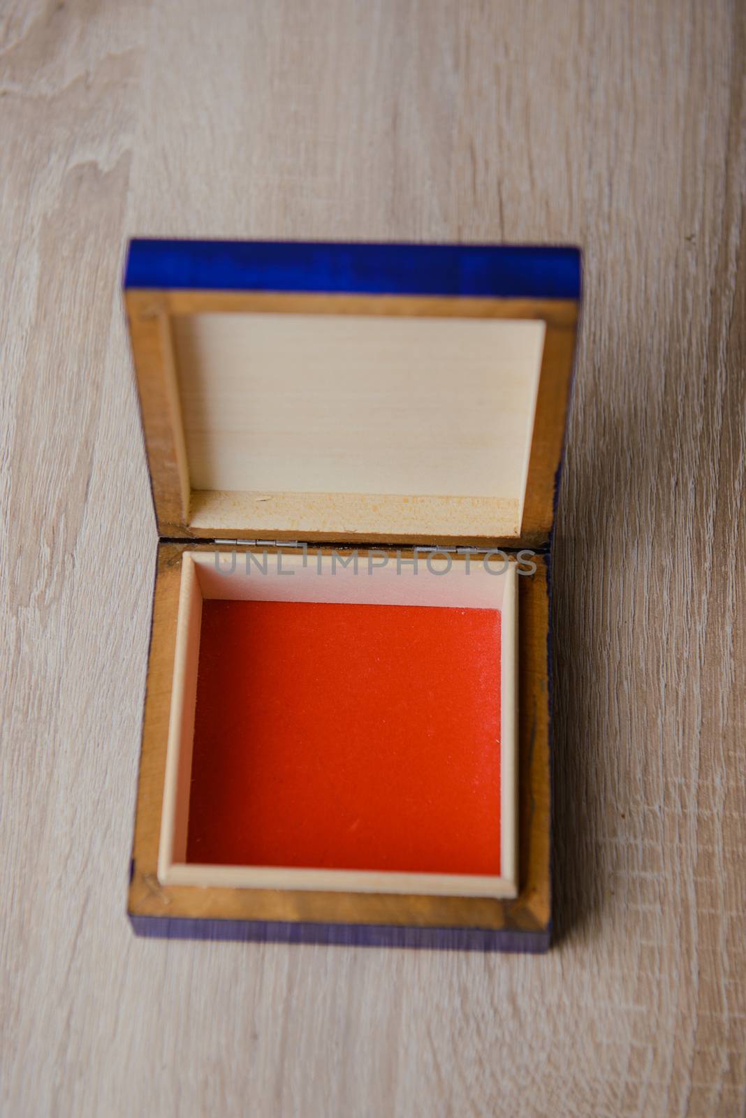 closed antique wooden blue jewelry box on the table.