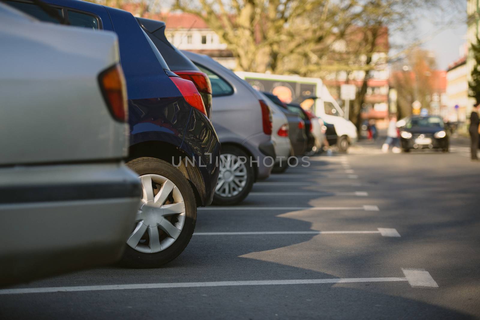 View of tightly packed cars in parking lot.