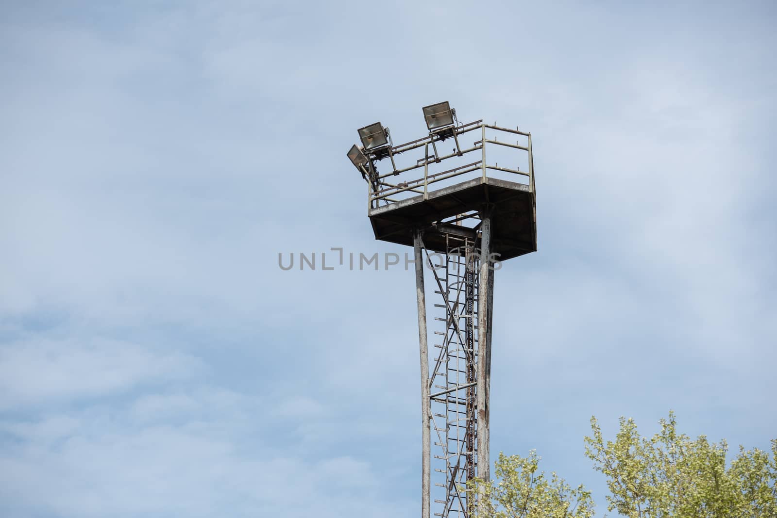 Observation tower with copy space. Blue sky and green trees