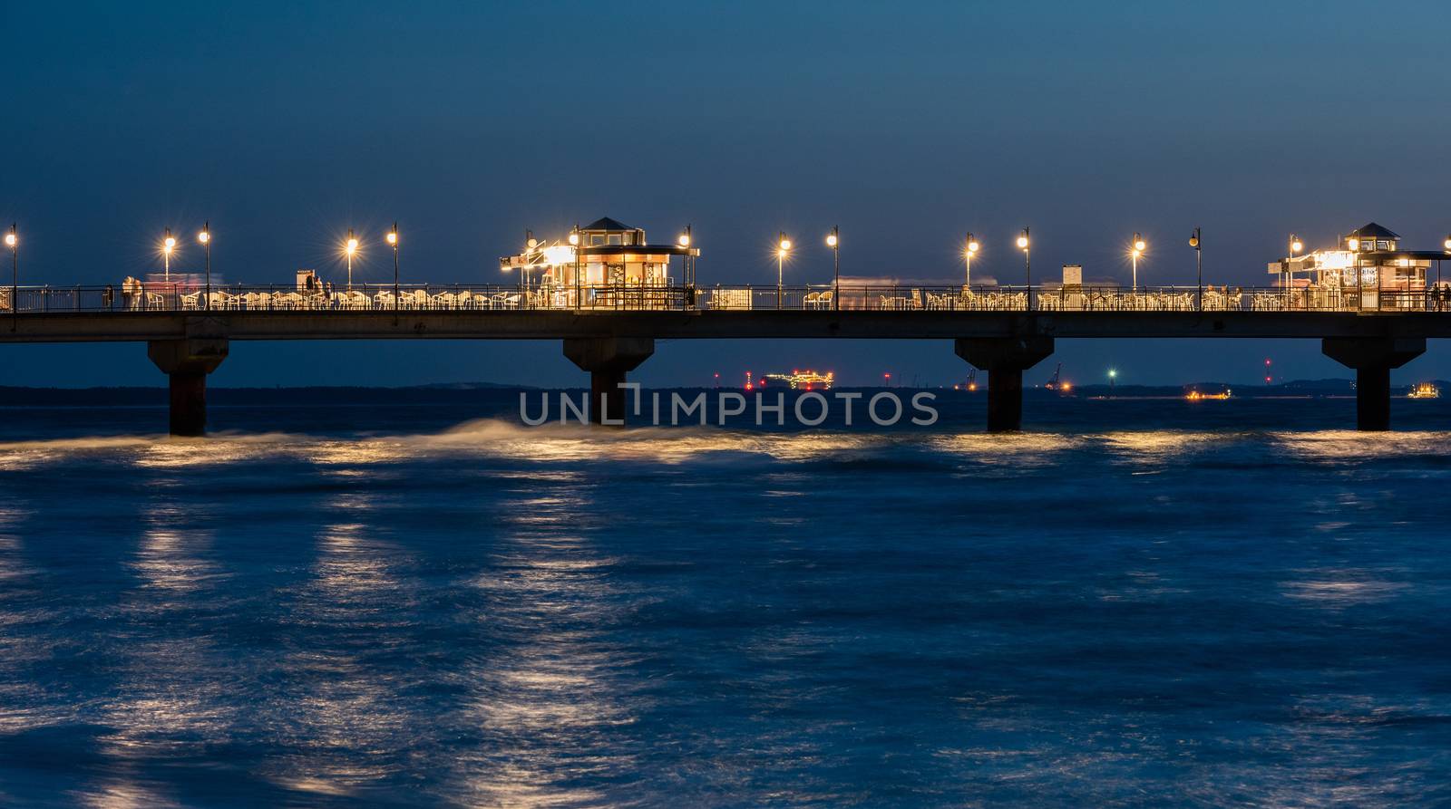 Baltic sea at beautiful sunset in Miedzyzdroje beach, city where the festival of stars takes place every year . Polish baltic coast. Famous city among the tourist. Pier at sunset