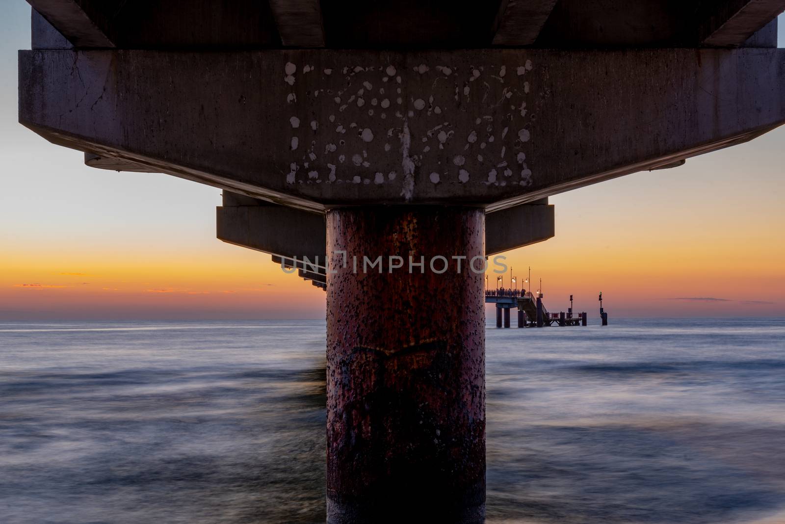 Baltic sea at beautiful sunset in Miedzyzdroje beach, city where the festival of stars takes place every year . Polish baltic coast. Famous city among the tourist. Pier at sunset