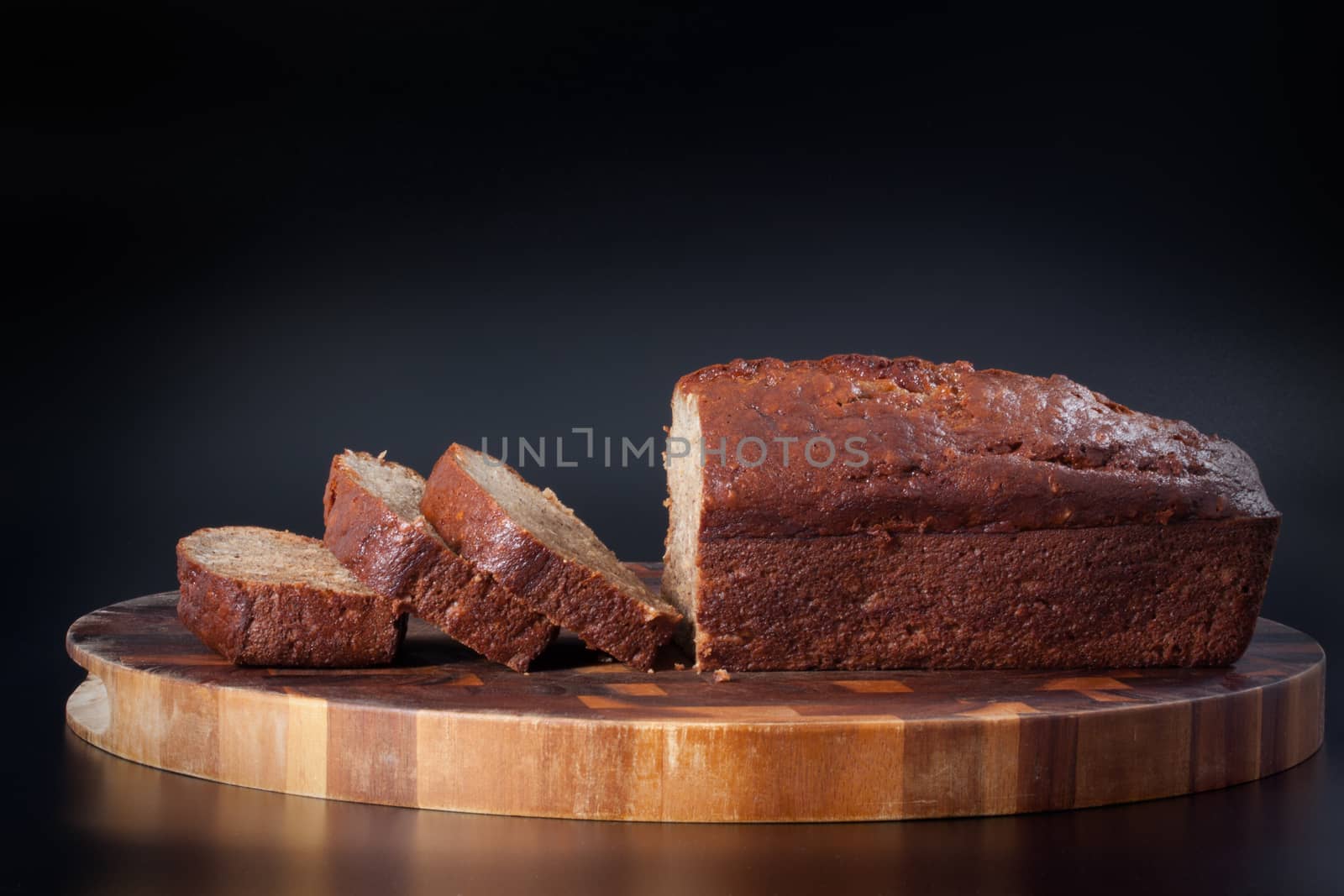 delicious homemade sliced banana bread on a wood plank 