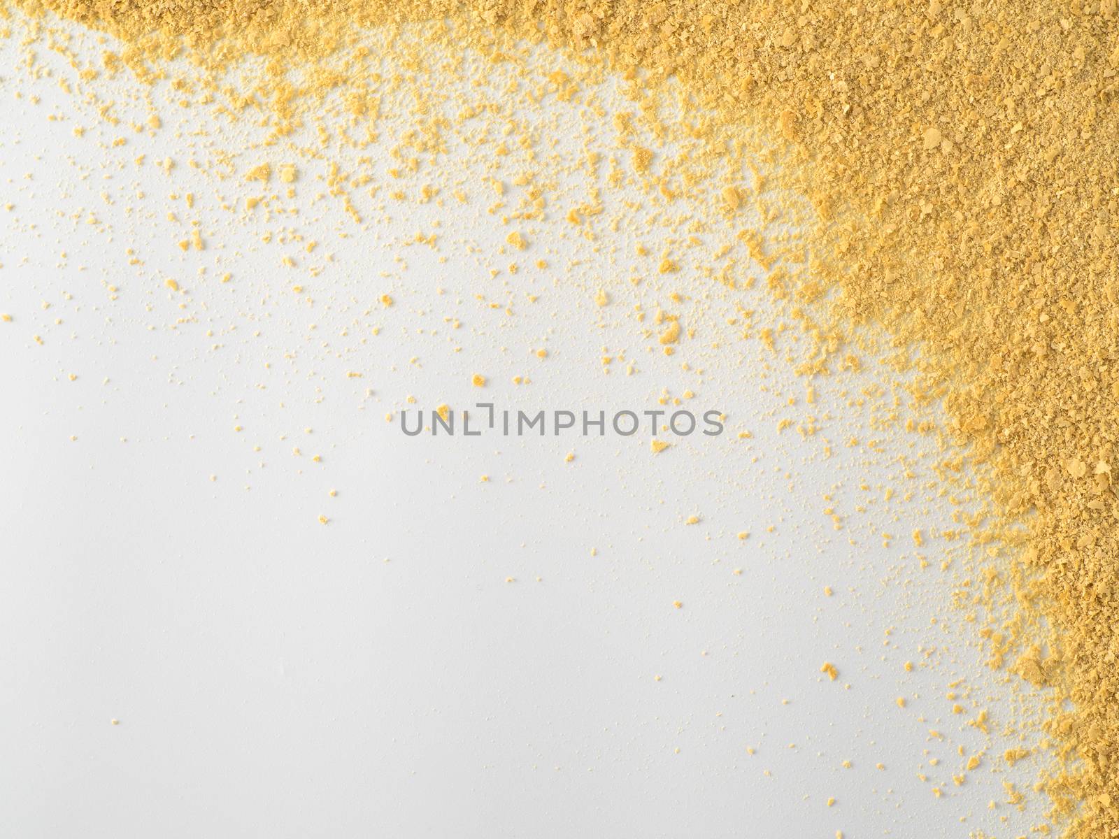 Nutritional yeast on white background. Nutritional inactive yeast top view. Copy space. Nutritional yeast is vegetarian superfood with cheese flavor, for healthy diet