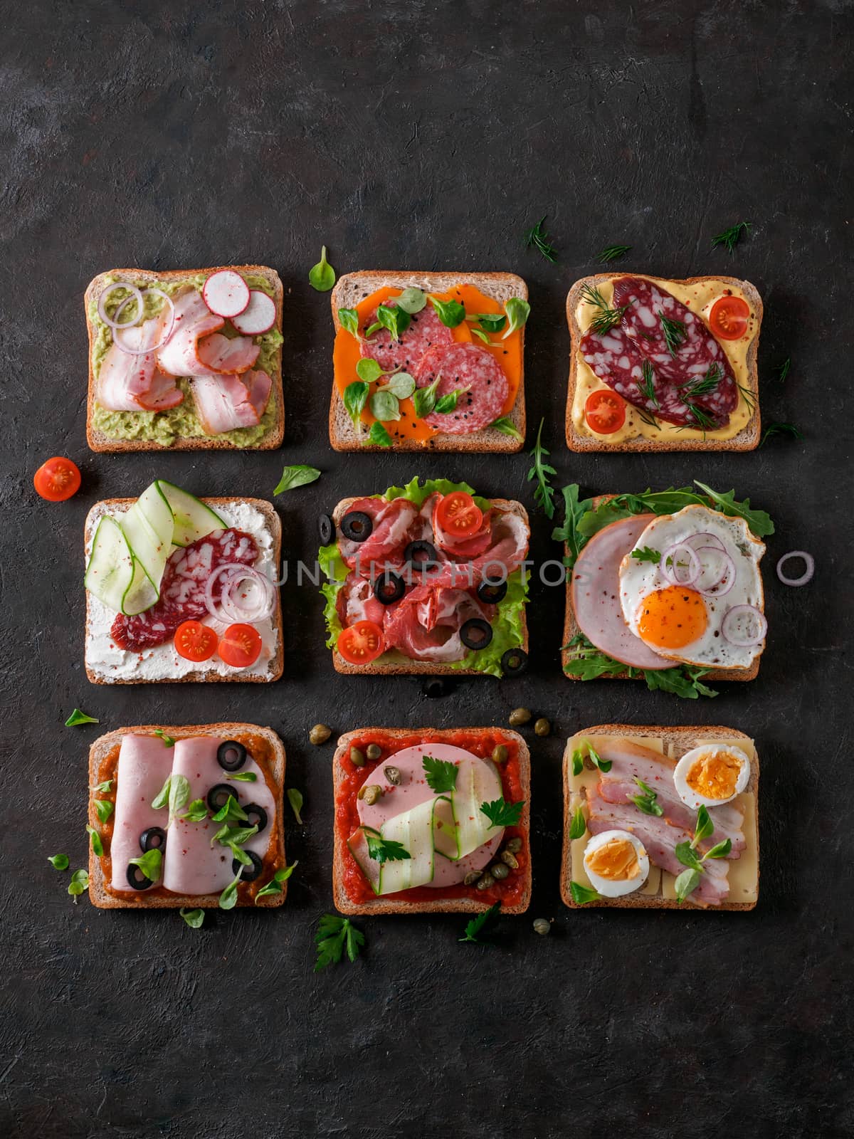 Set of eight different sandwiches with meat in square shape, copy space for text. Top view or flat lay. Assortment meat toasts on black background. Idea, creative concept for sausage maker. Vertical