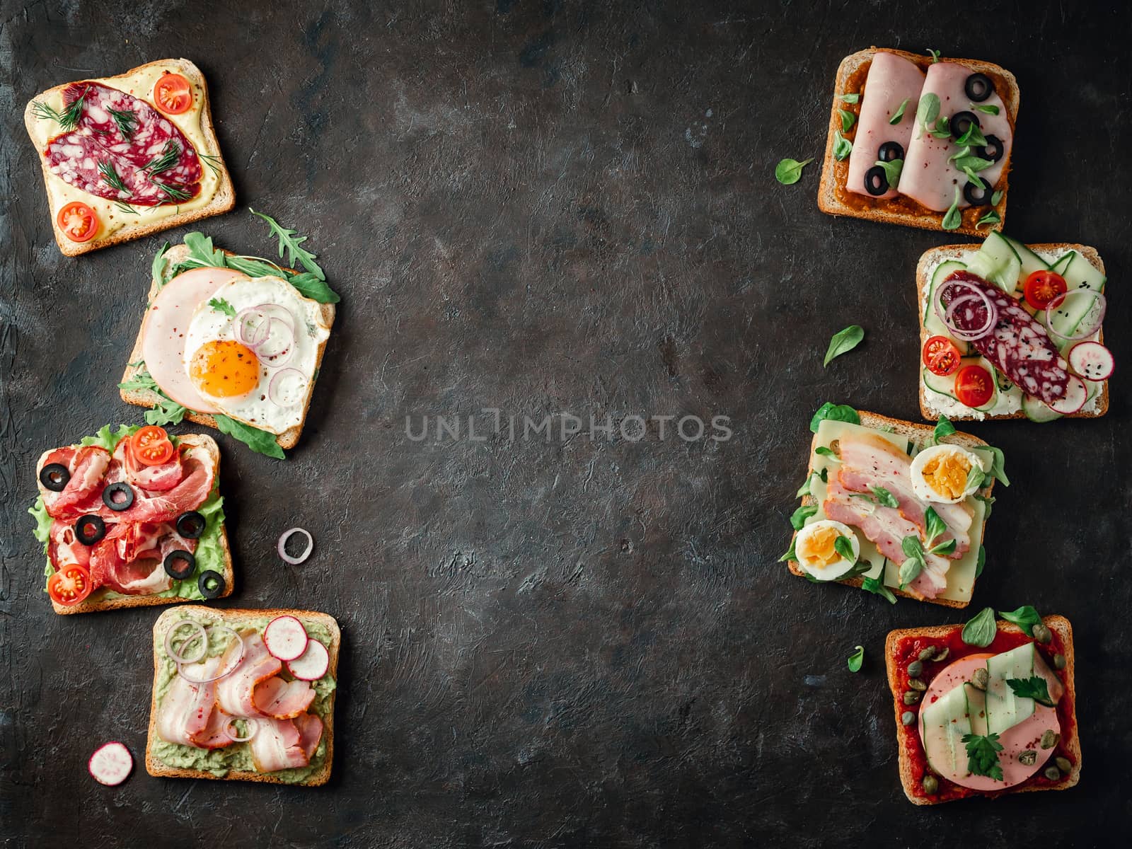 Set of eight different sandwiches with meat, copy space for design or text in center. Top view or flat lay. Assortment meat toasts on black background.Idea,creative layout or concept for sausage maker