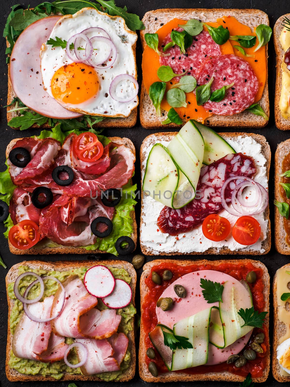 Set of eight different sandwiches with meat in square shape. Top view or flat lay. Assortment meat toasts on black background. Idea, creative concept for sausage maker