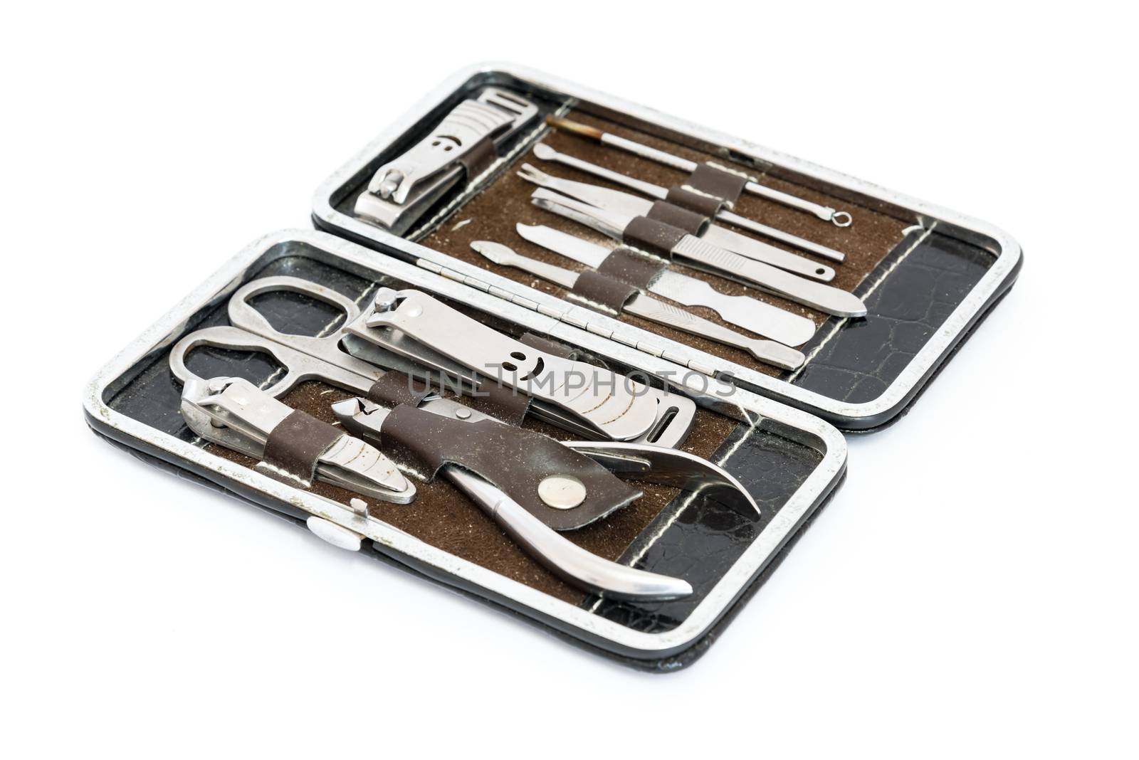 Studio shot grooming kit and nail tools in travel case isolated on white by trongnguyen