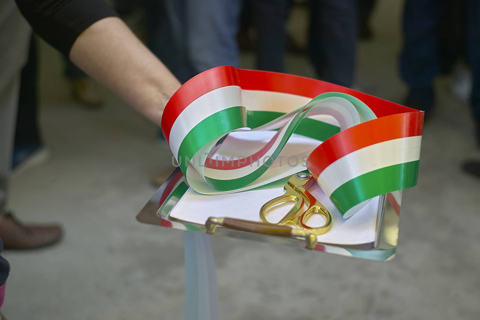 Ribbon with Italian flag in a scissor tray, used for institutional ceremonies as inauguration of new projects and activities. Cutting of the ribbon.