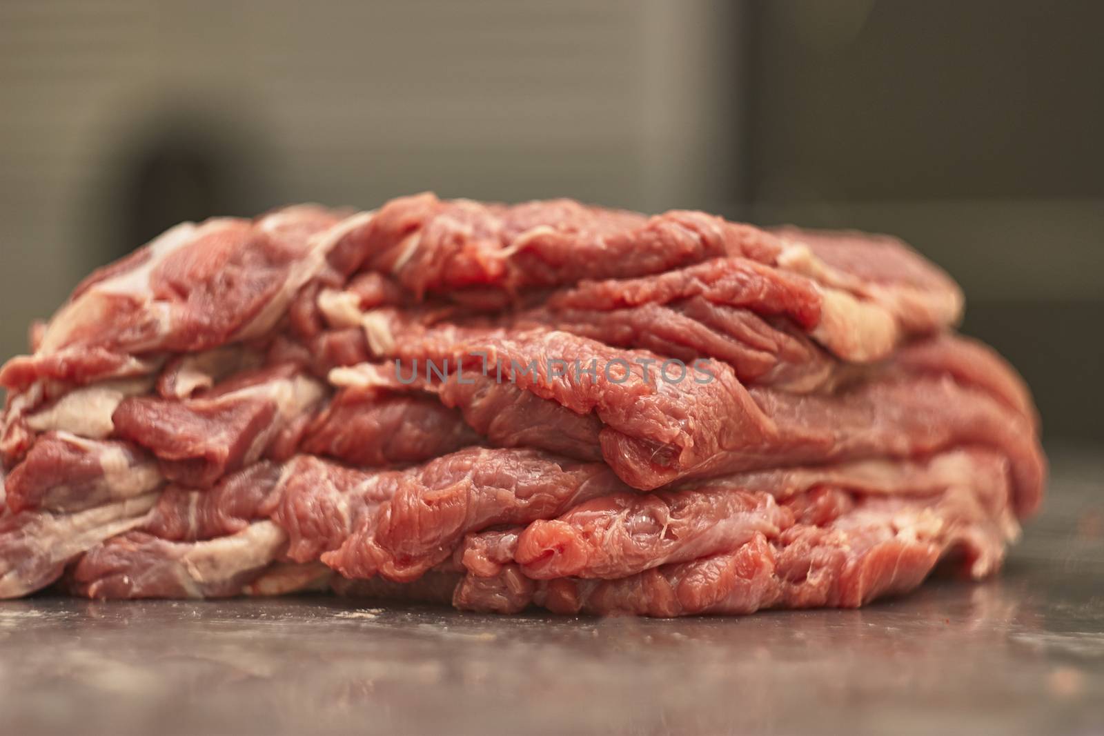 Detail of the fibers of a cut of veal with macro shot made in a butcher shop. Red meat from organic farming.