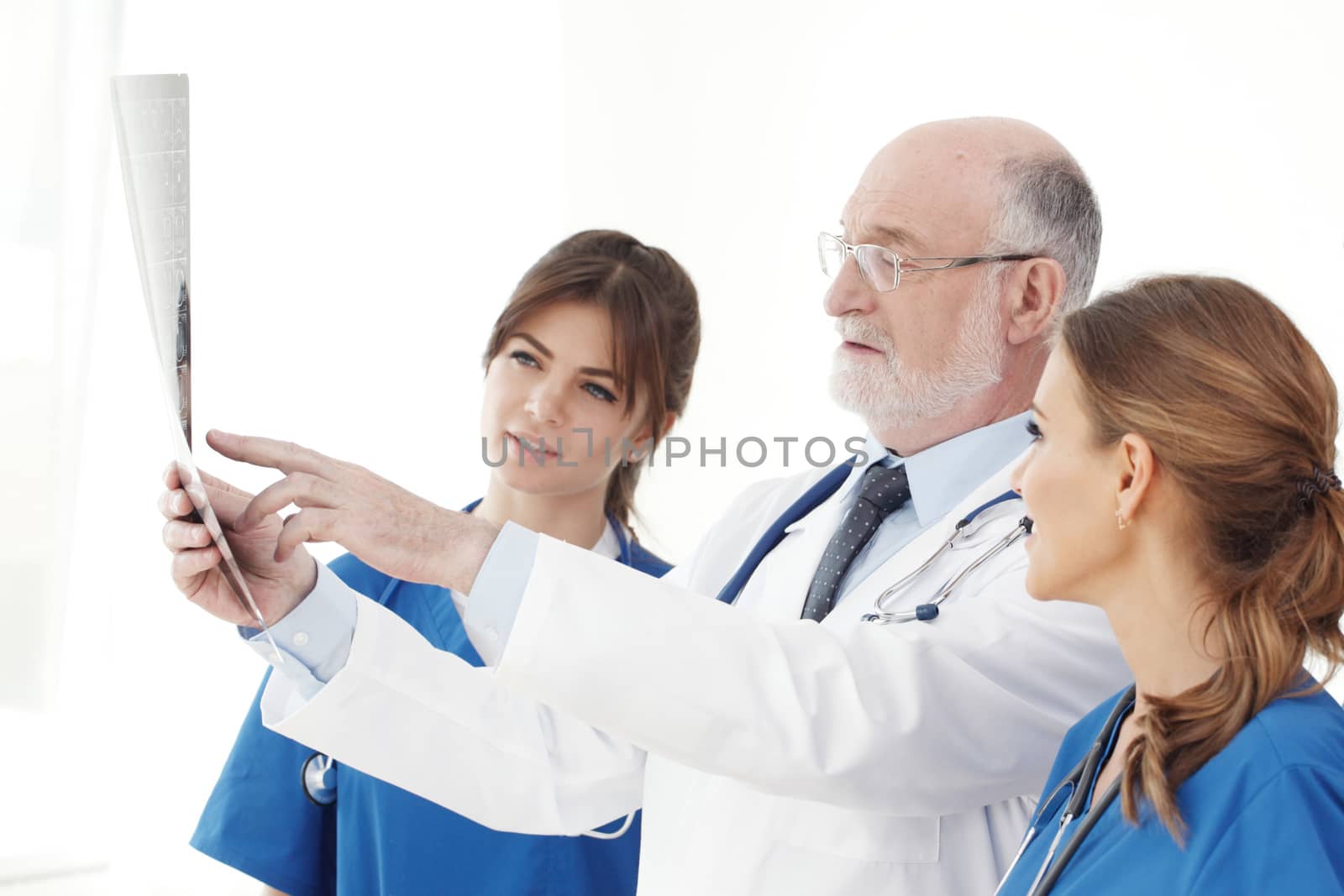 Medical team checking on X-ray results isolated on white