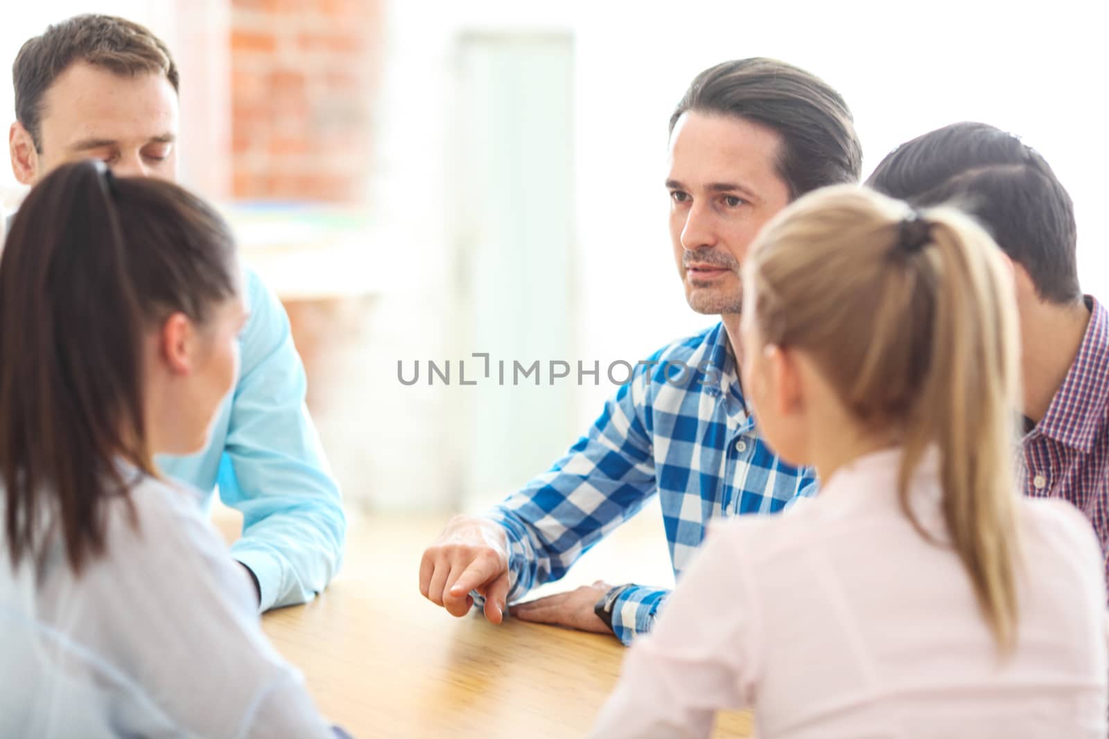 Startup diversity teamwork brainstorming meeting concept, people sitting around the table