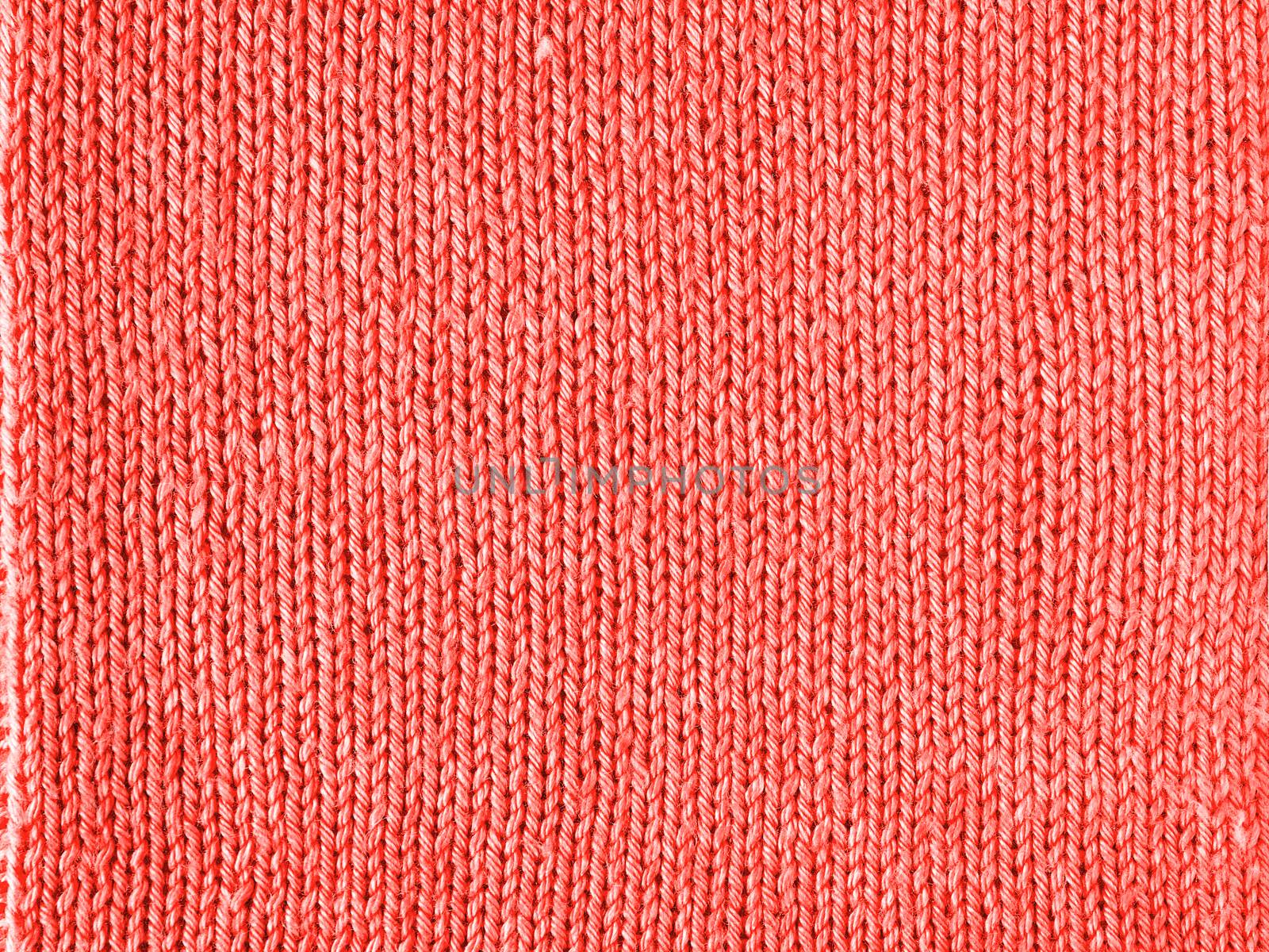 Knitted Living Coral texture jersey as background by fascinadora