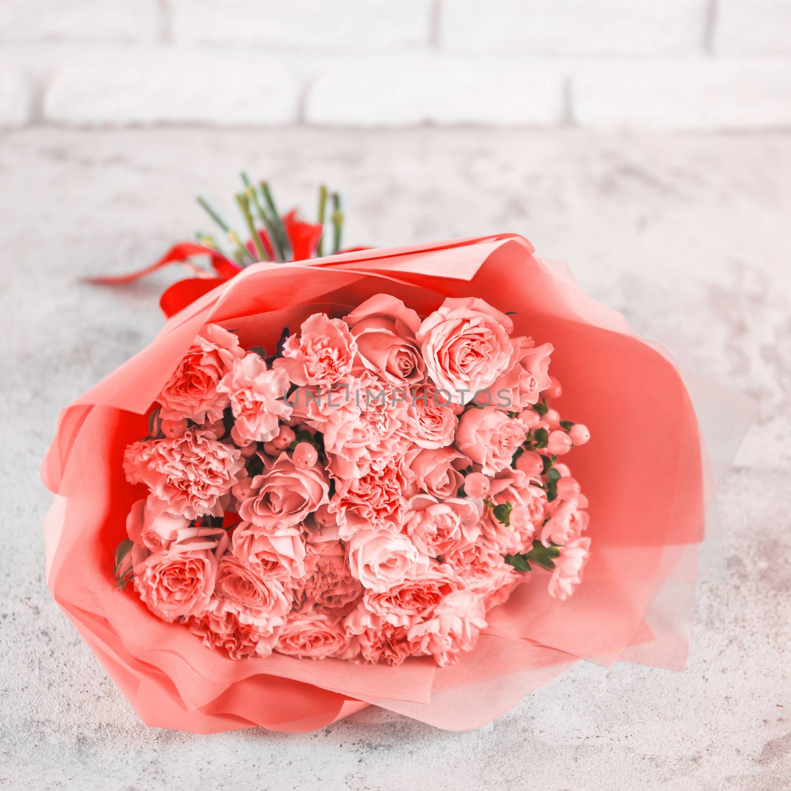 Beautiful bouquet with roses, dianthus, hypericum, clove in color of year 2019 Living Coral concept. Trendy color Living Coral in flowers, wedding bouquet. Square format